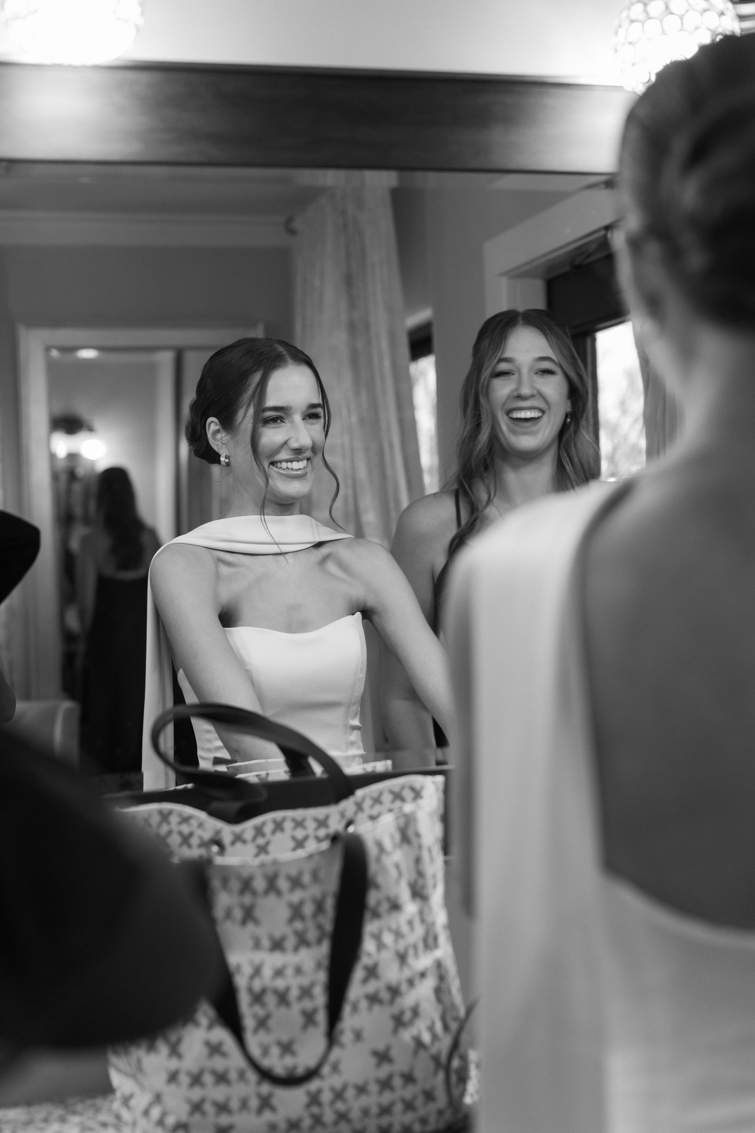 Black and white candid moments of wedding party preparations in a bridal suite.