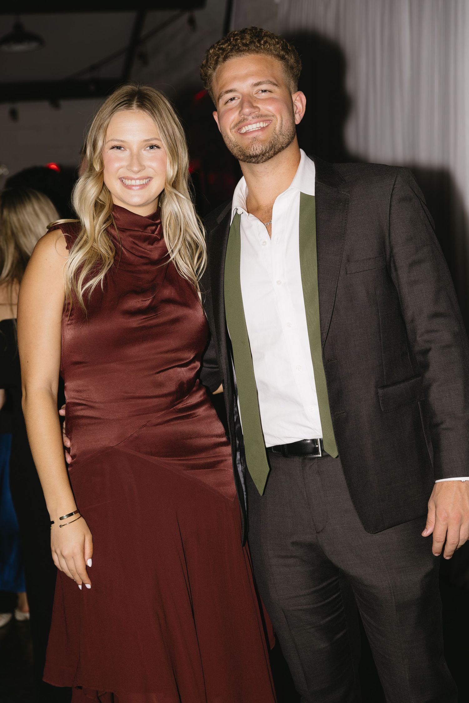 Formal event attendees posing together at an evening celebration.