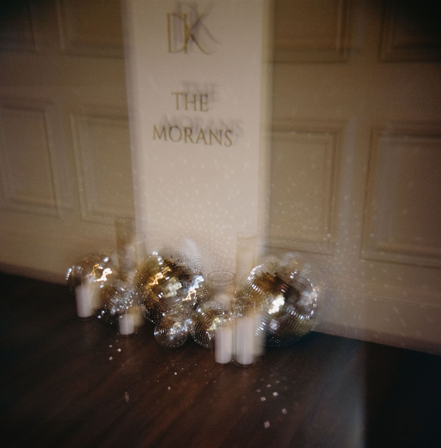 Wedding accessories and jewelry arranged on a floor with text visible on the wall above.