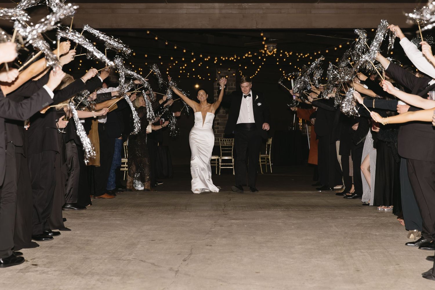 Wedding guests forming a sparkler tunnel exit for the newlyweds.