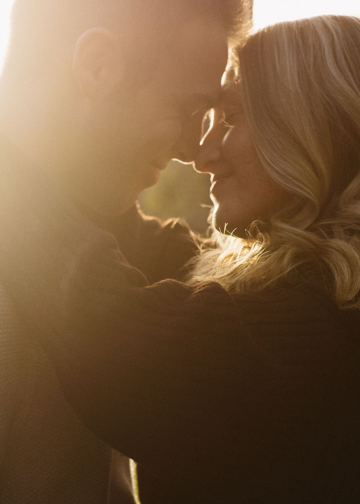 Silhouette of a person in golden sunlight with a dramatic backlit glow creating an ethereal atmosphere.