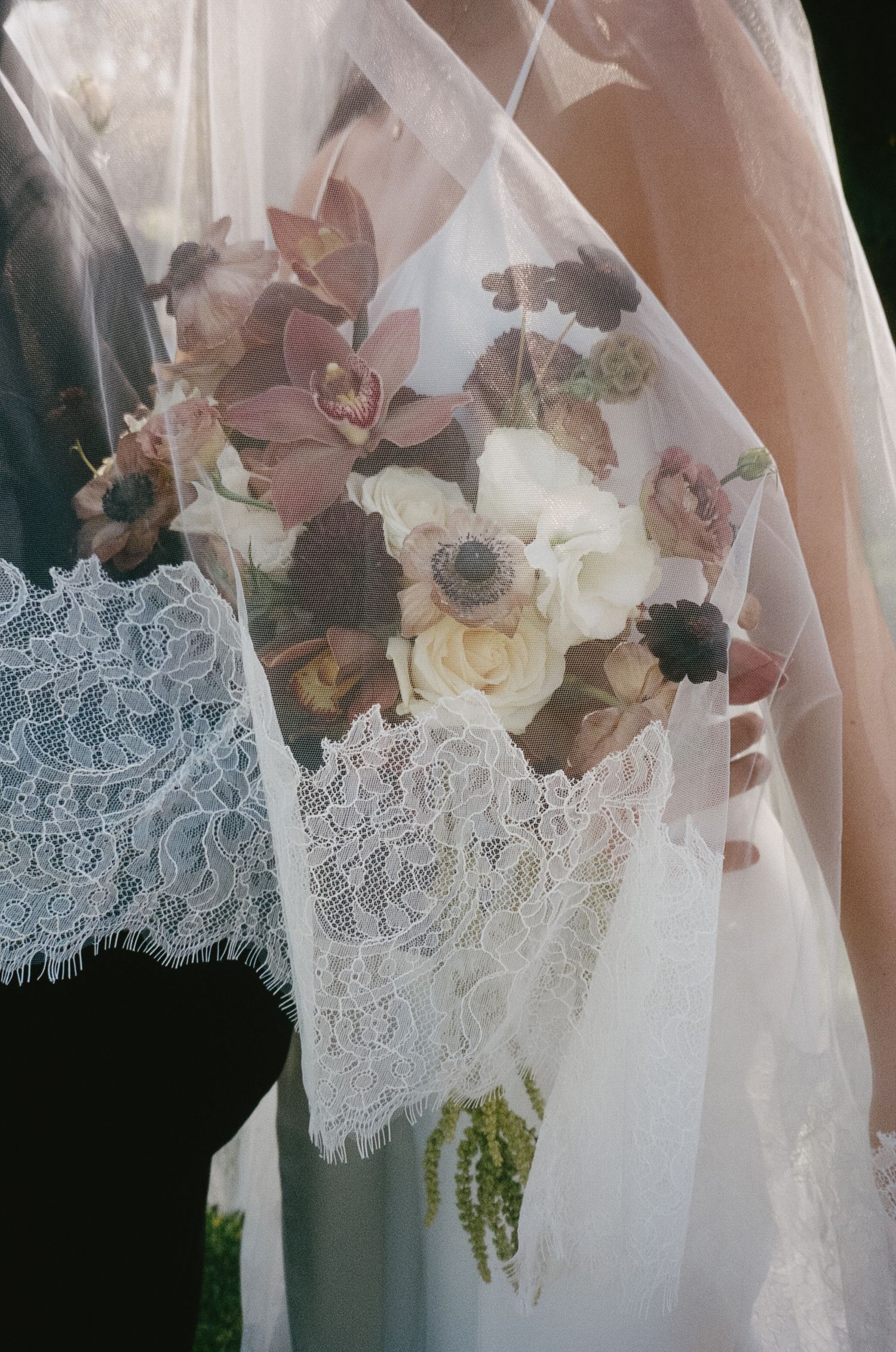 Delicate lace trim and floral details adorn a white wedding veil.