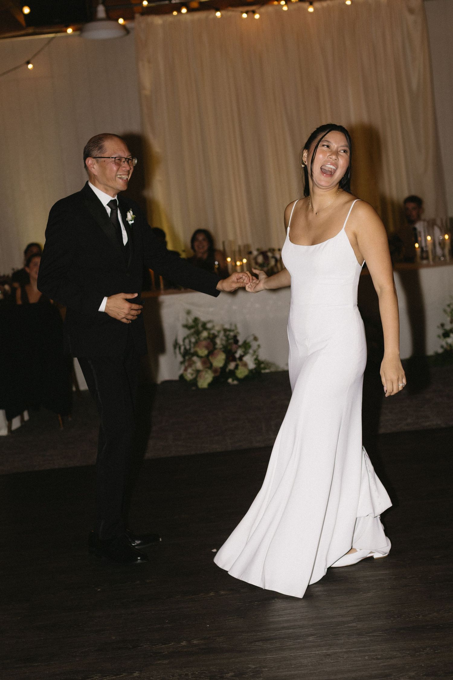 Wedding reception dance floor with bride in flowing white dress.