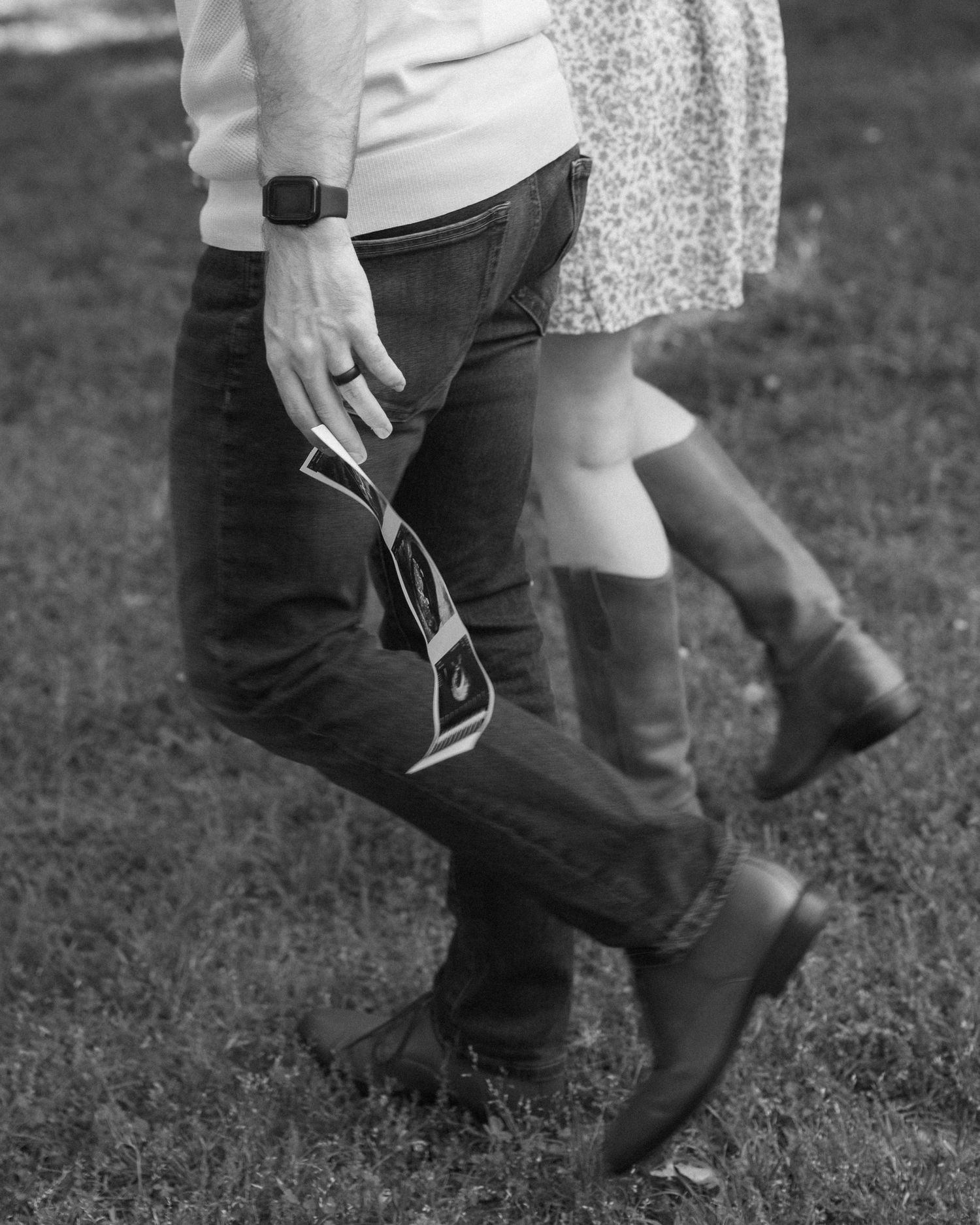 Black and white sequence showing feet dancing on grass, capturing sequential movement of a classic swing dance step.