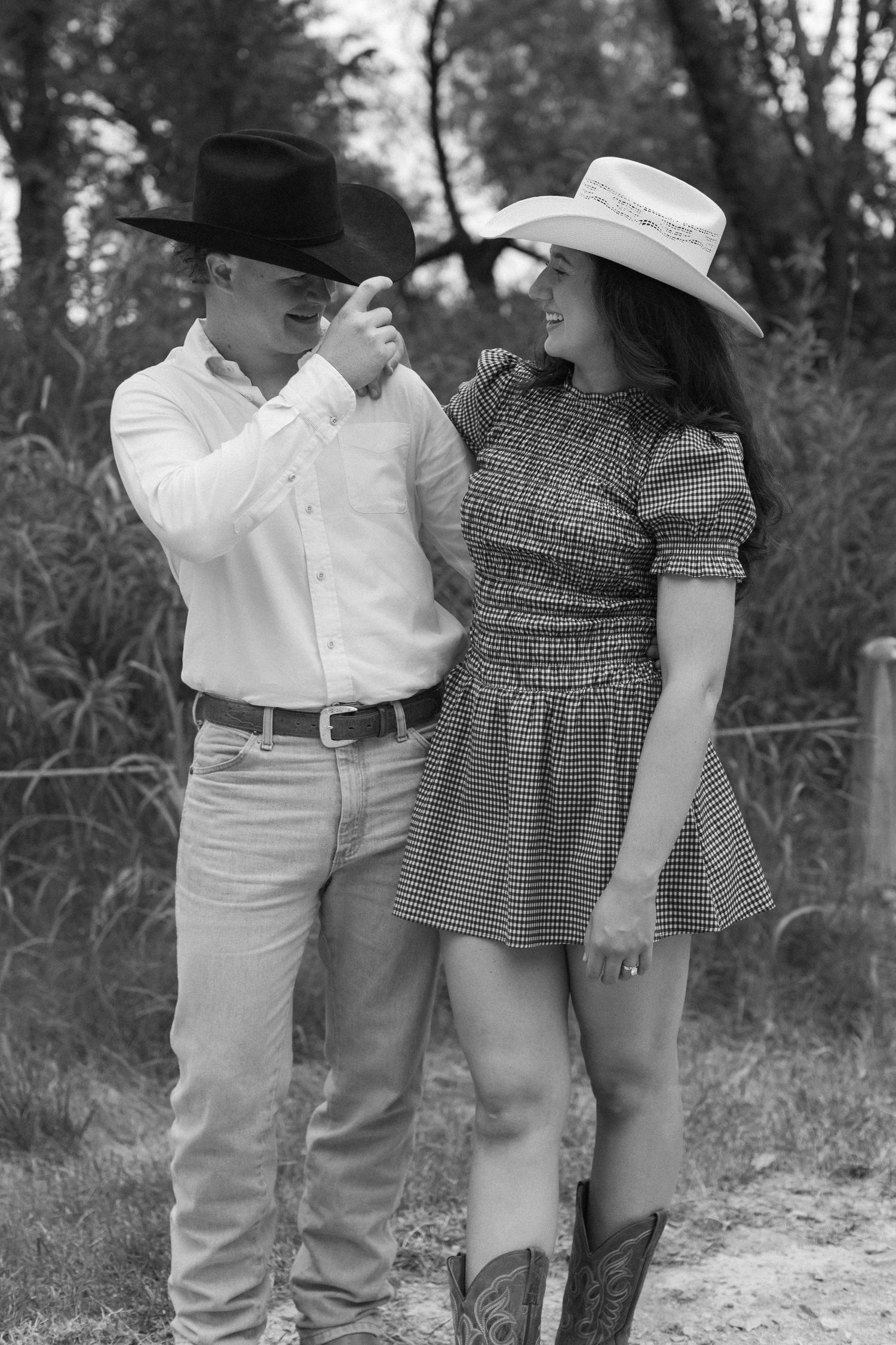 Children in vintage attire and hats line up in black and white photography.