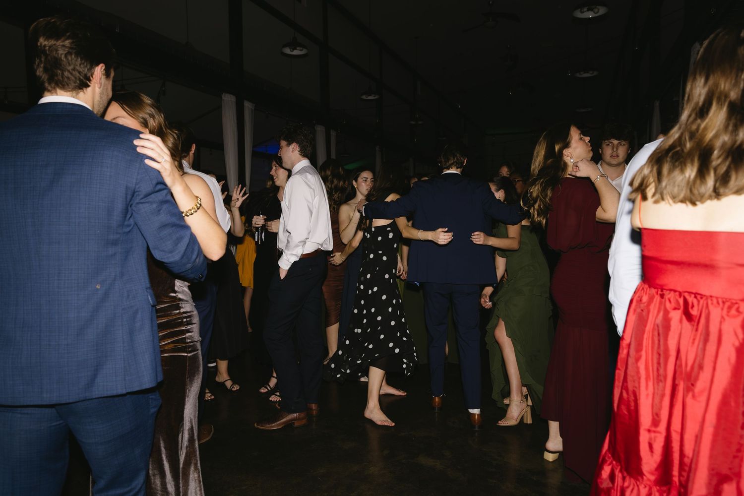 Lively dance floor scene with guests celebrating at a wedding reception.