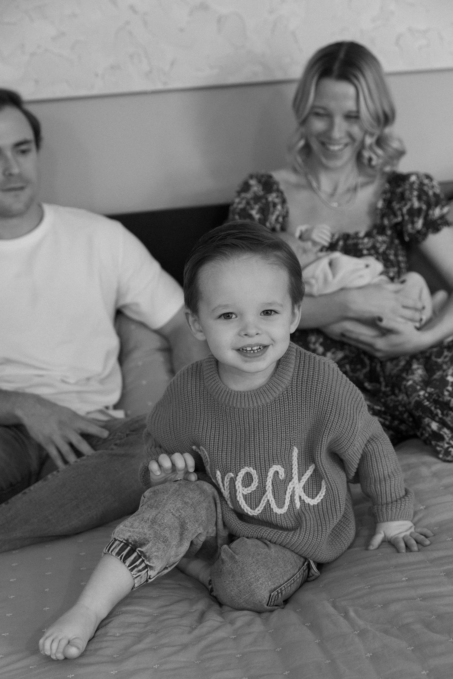 Black and white series of playful family interactions on a comfortable couch.