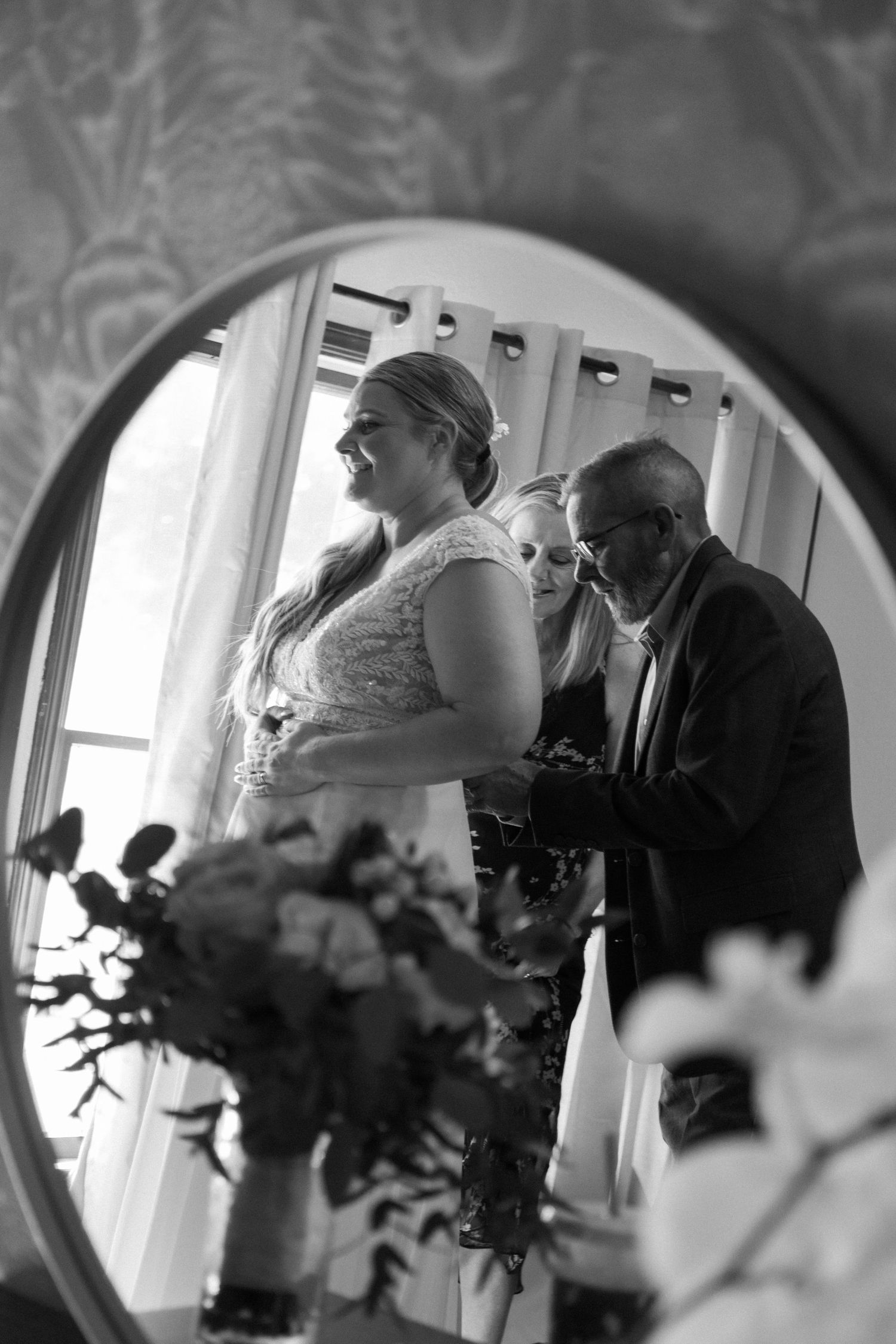 Black and white mirror reflection of wedding preparations.