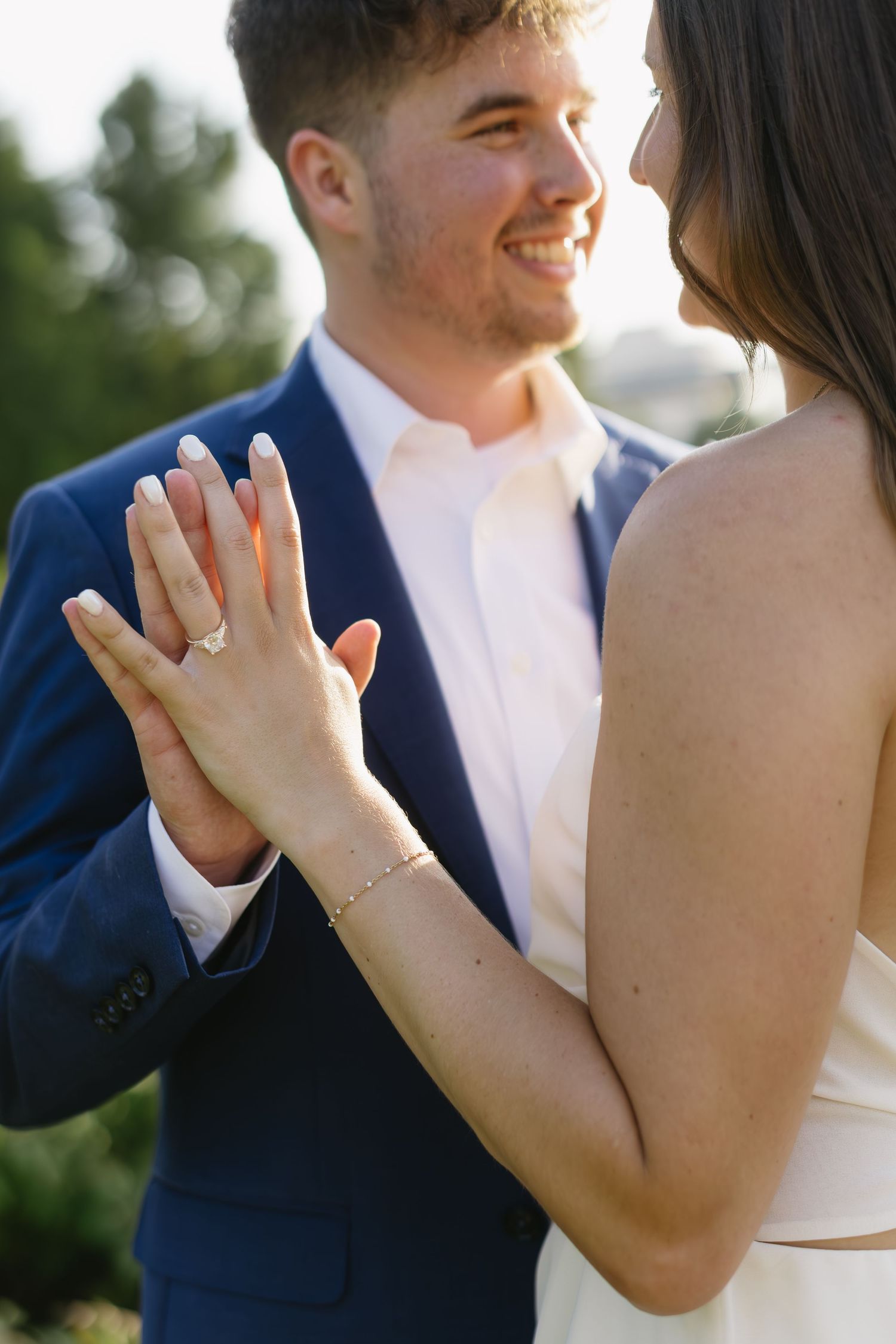 Close-up shots of a couple's hands and arms during intimate moments outdoors.