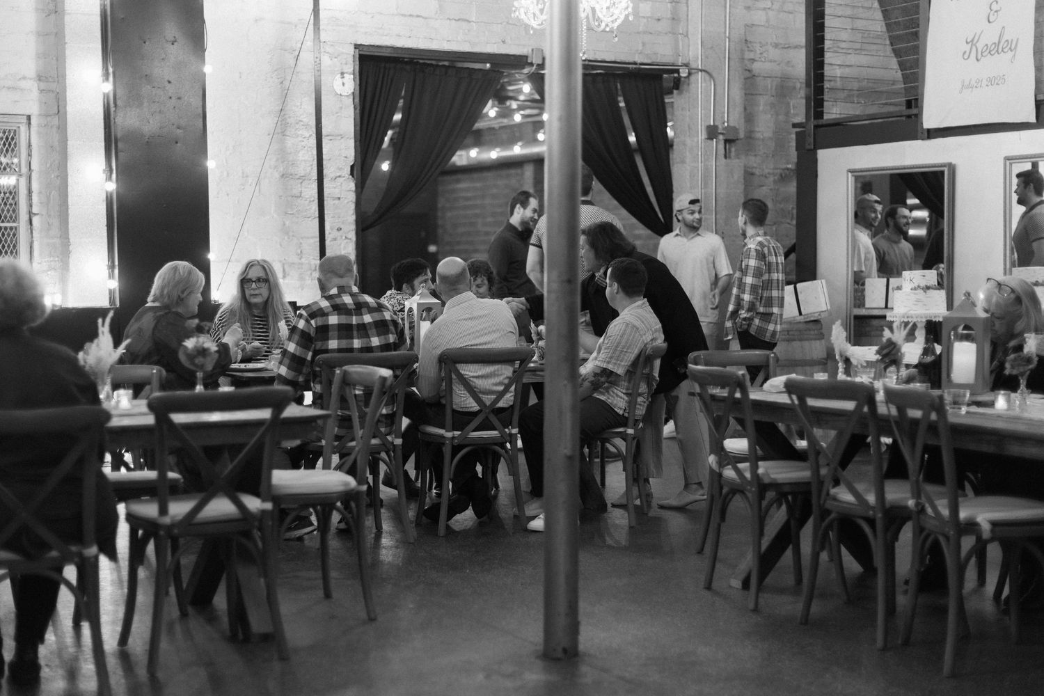 Interior view of a rustic venue with tables and chairs set up for an event.