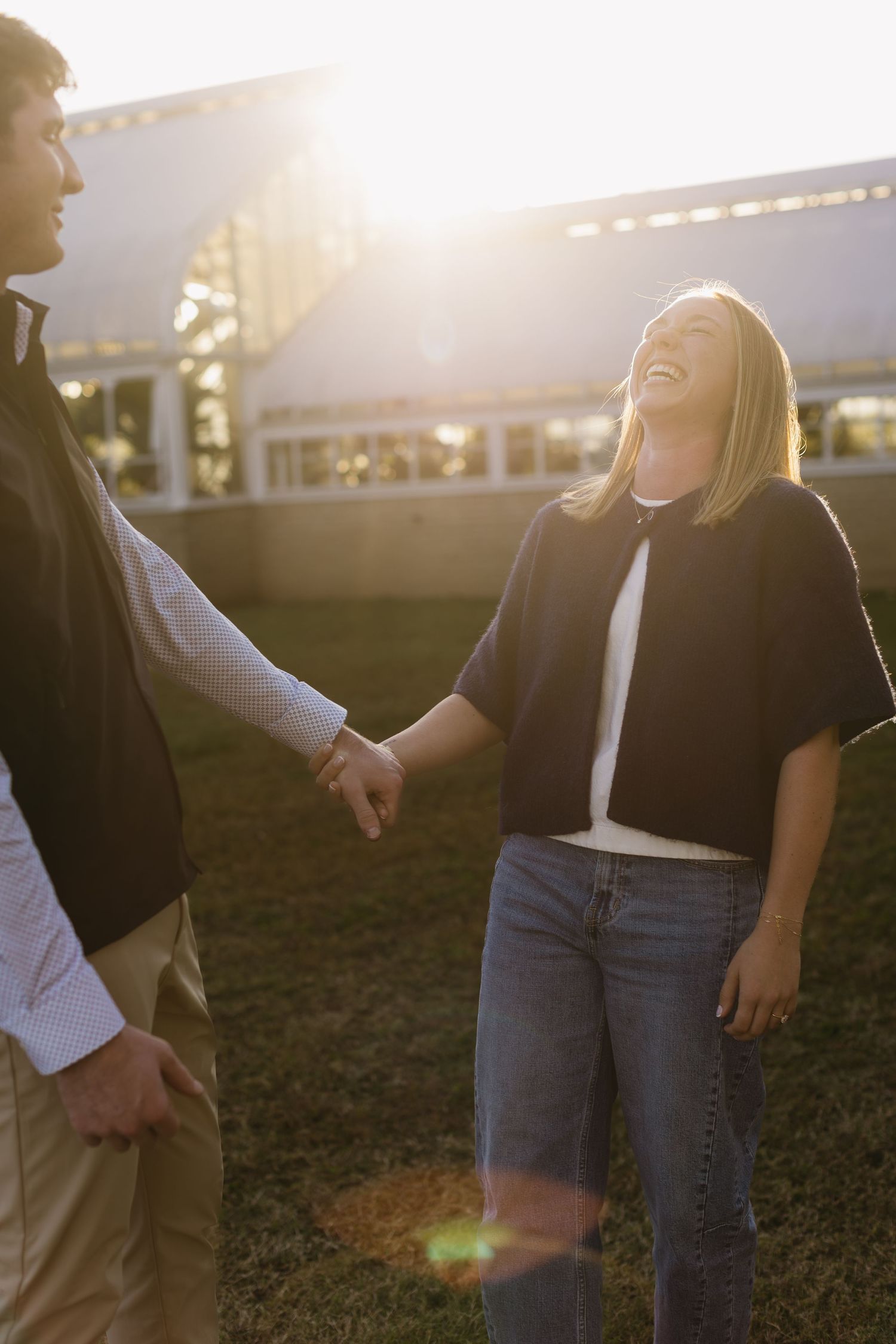 Couple sharing joyful moments in warm sunset light.
