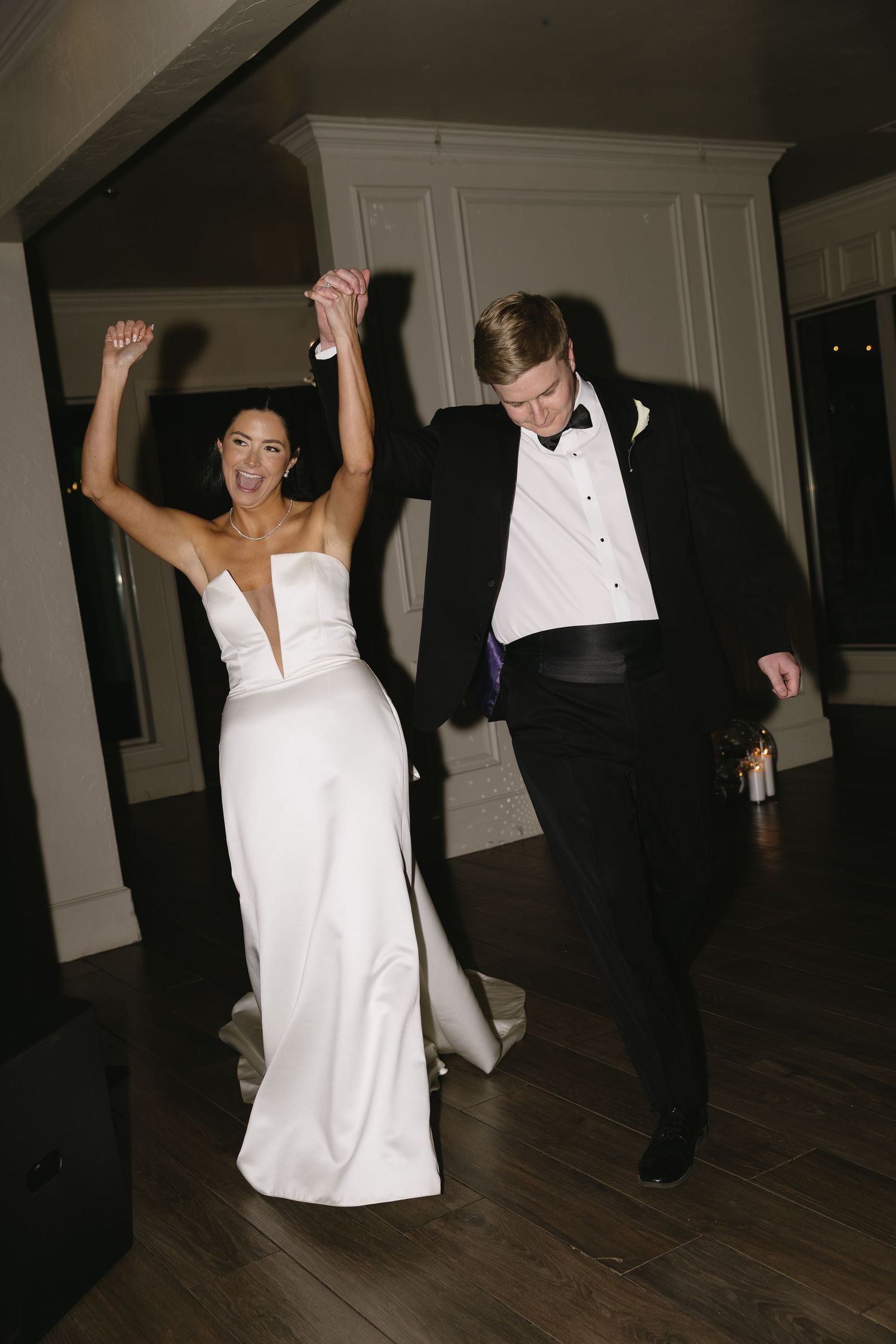 Wedding reception dance floor with guests dancing in formal attire.