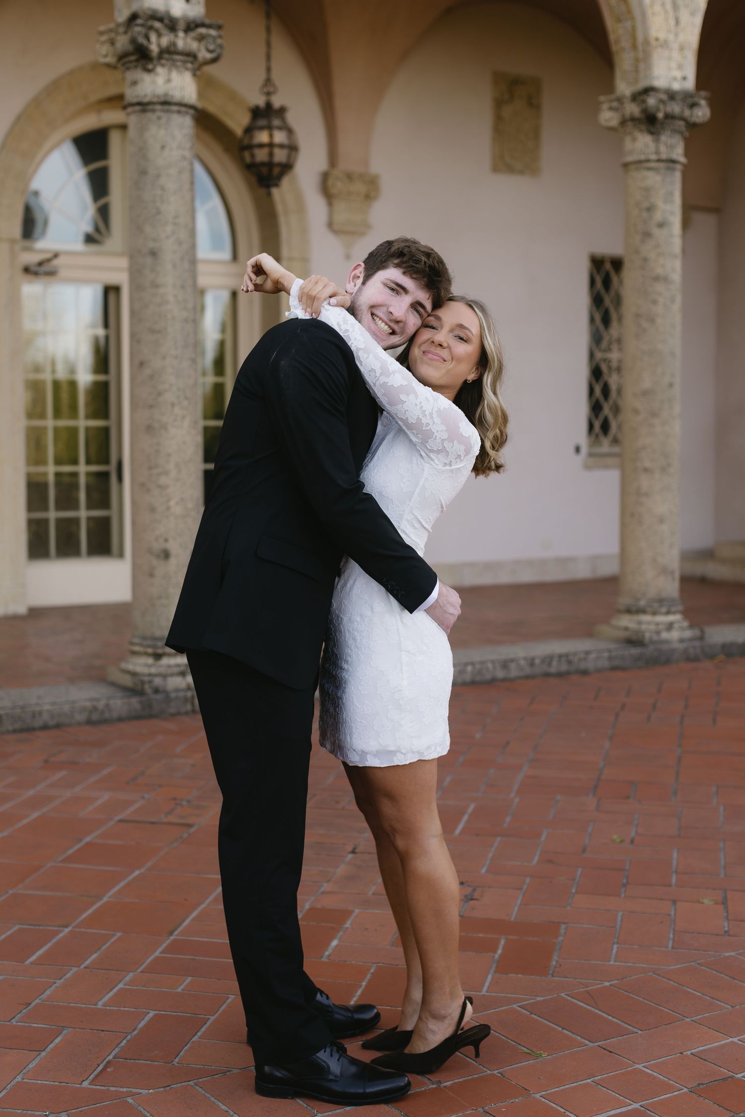 Playful dance moves photographed in sequence under ornate stone archways and columns.
