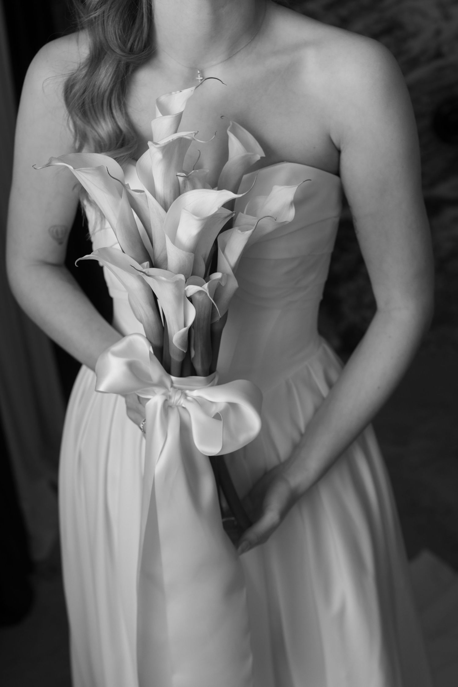 Elegant white wedding dresses with delicate floral details and ruching shown in a series of cropped detail shots.