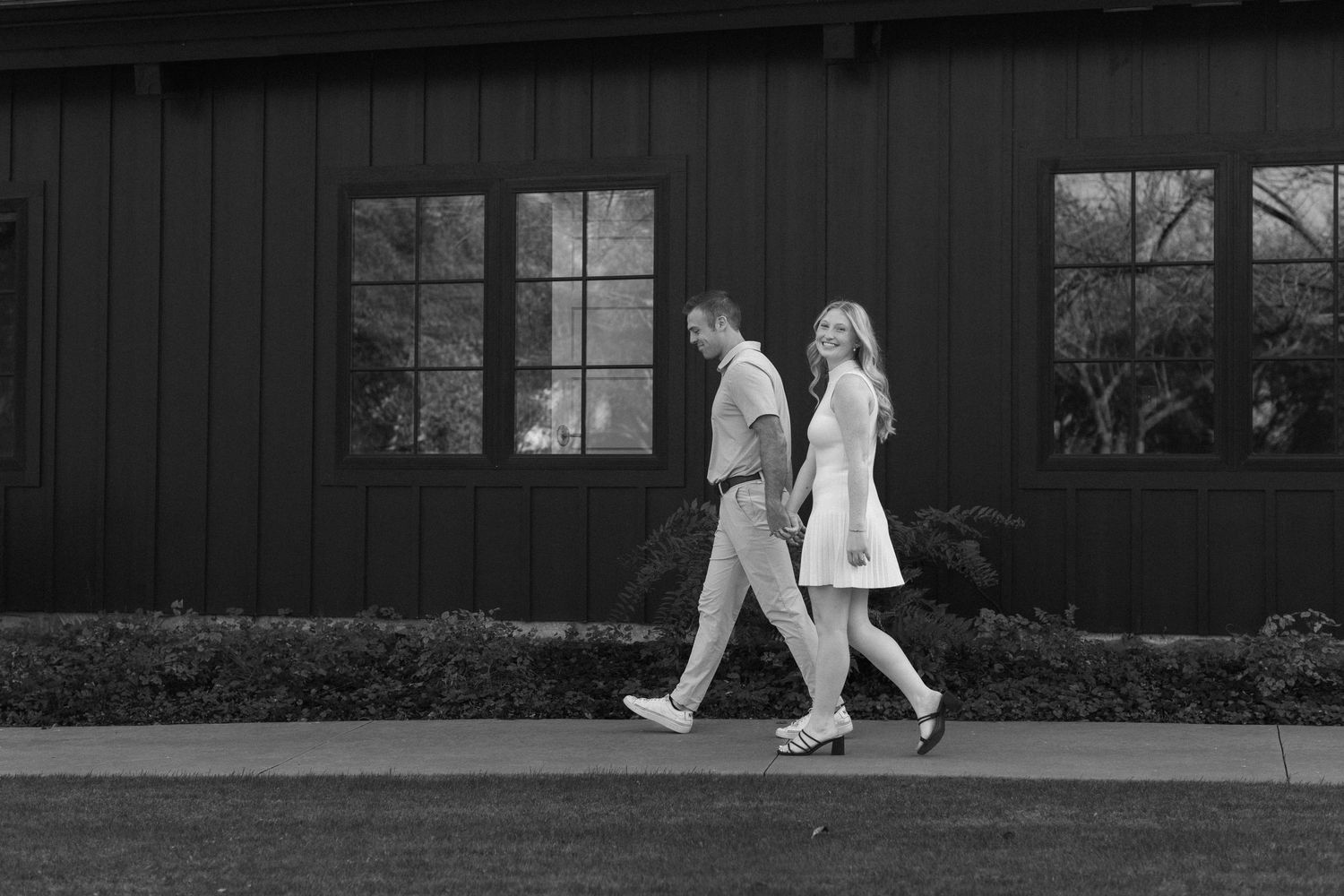 A series of black and white photos showing people walking past a building's exterior windows and walls.