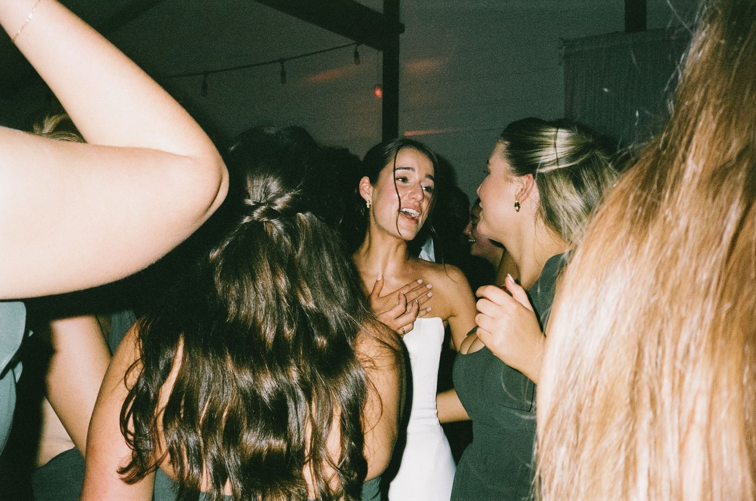 Candid shots of wedding guests dancing and celebrating at a lively reception.