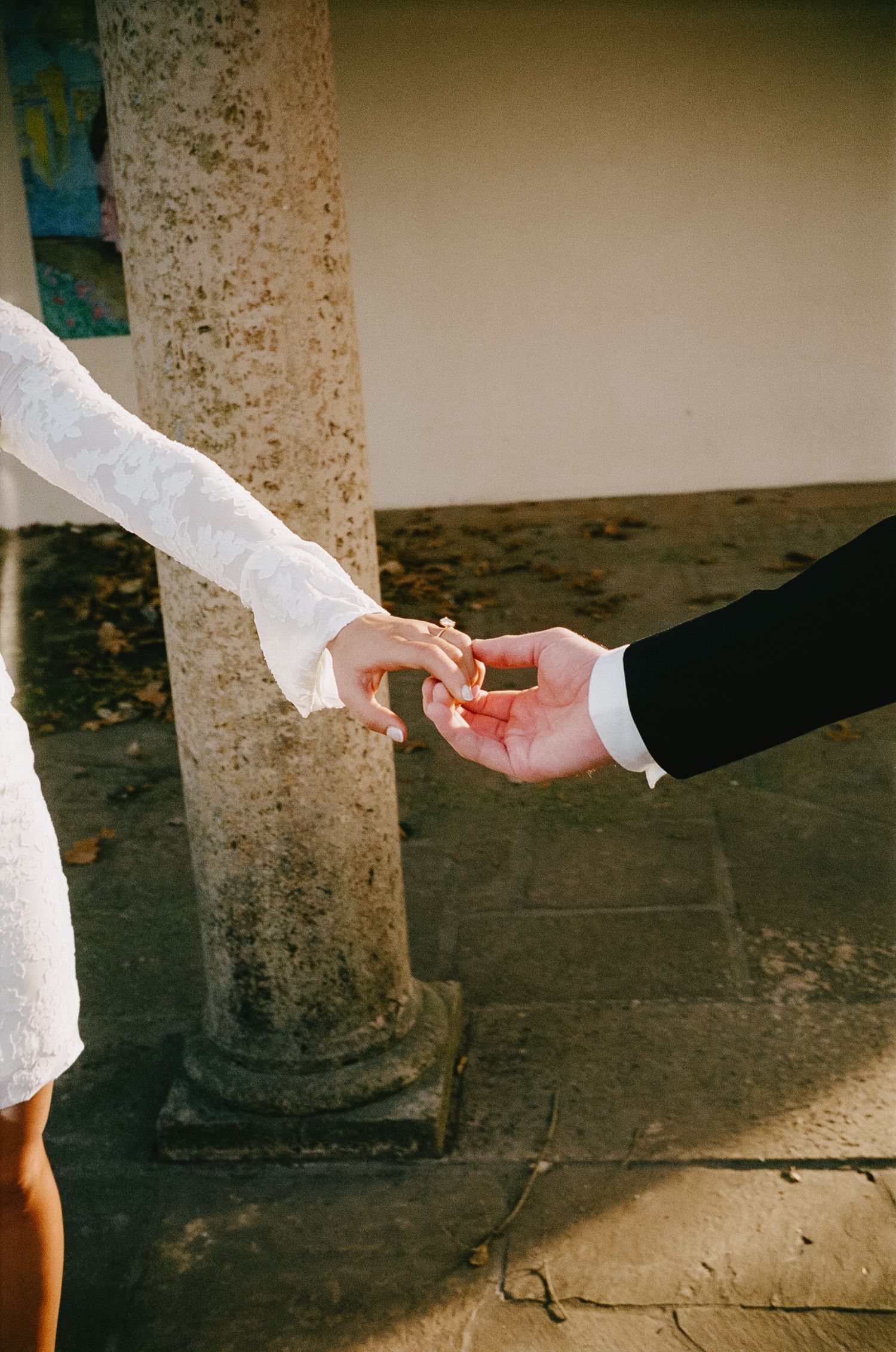 Sequential photos showing hands reaching out to connect in white sleeves.