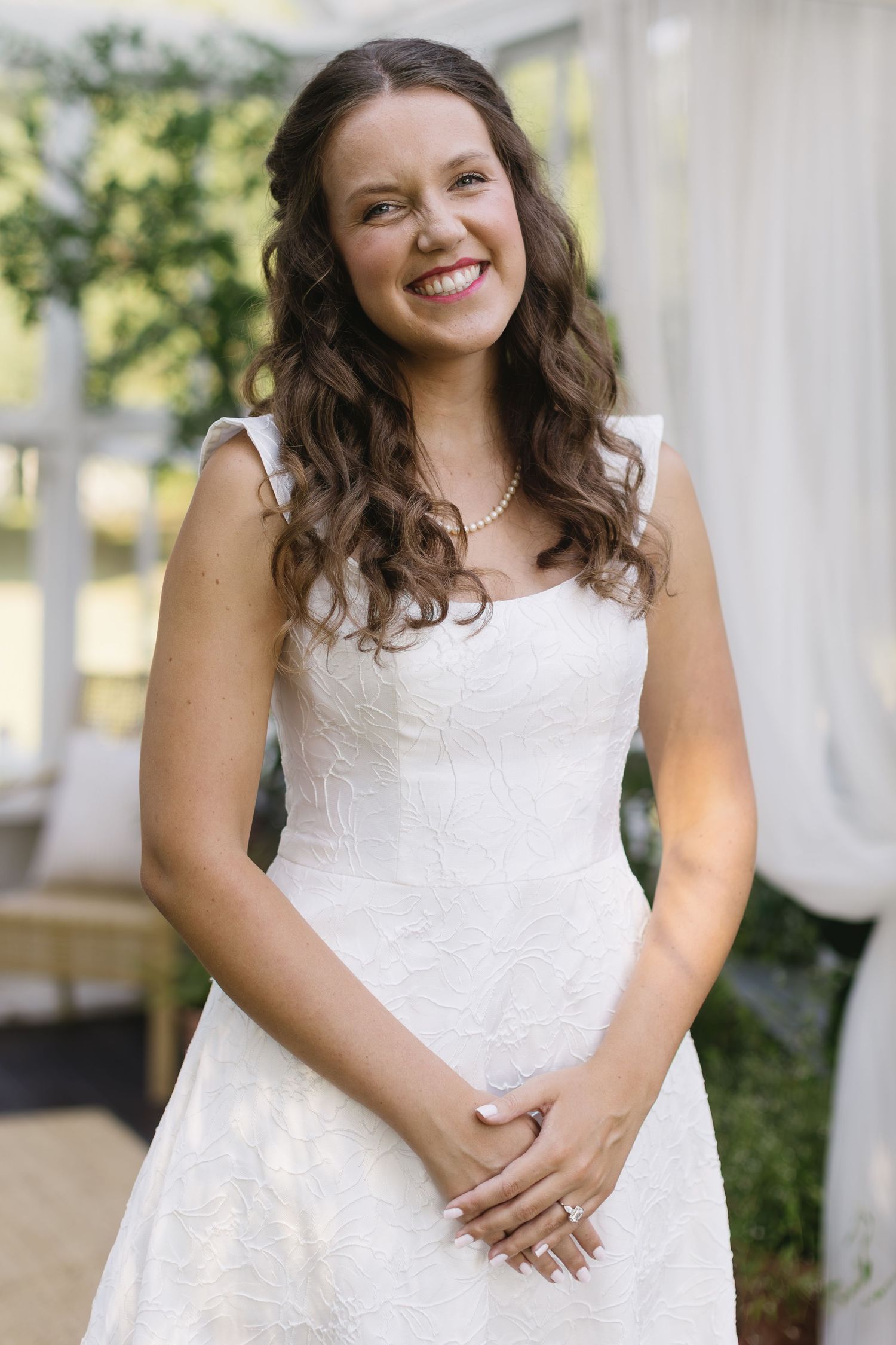 A bridal portrait session features elegant poses in a white dress against a garden setting.