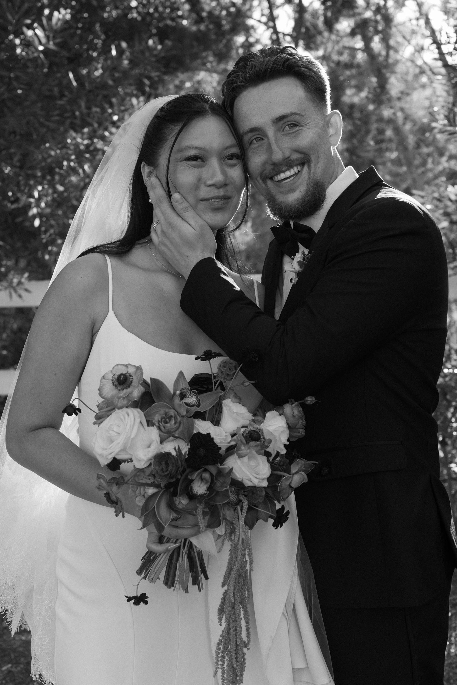 Black and white wedding portraits showing tender moments between newlyweds.
