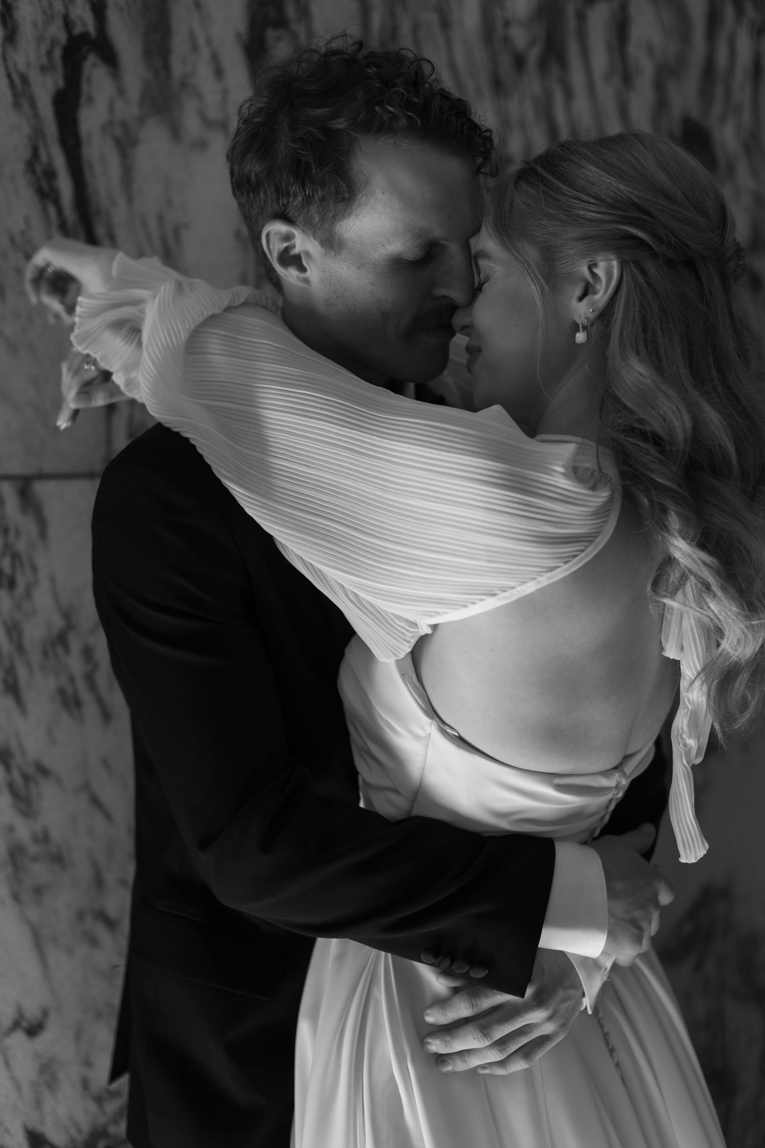 Black and white romantic wedding portrait showing an intimate embrace.