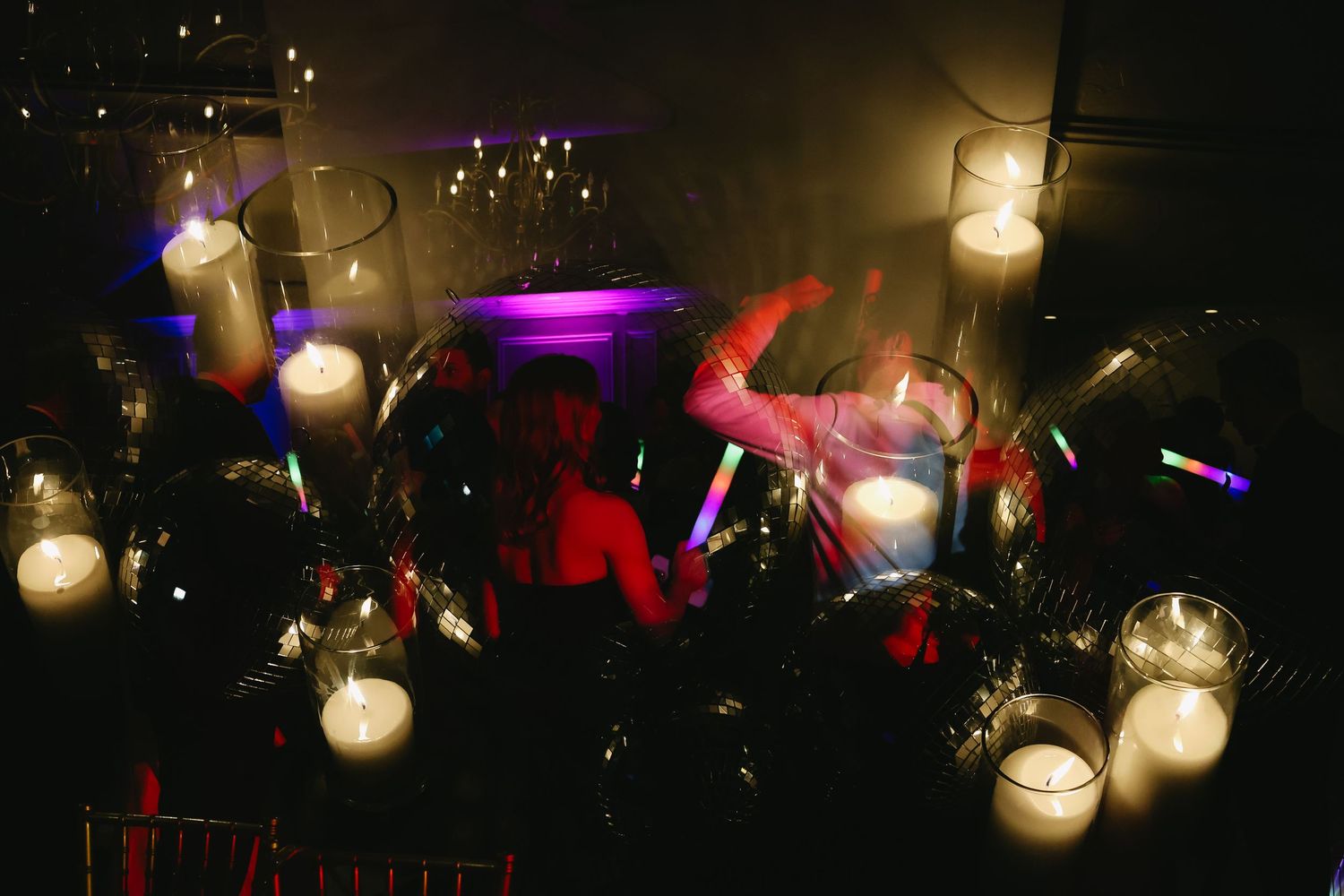 Colorful party lights and decorations create ambient atmosphere at nighttime celebration.