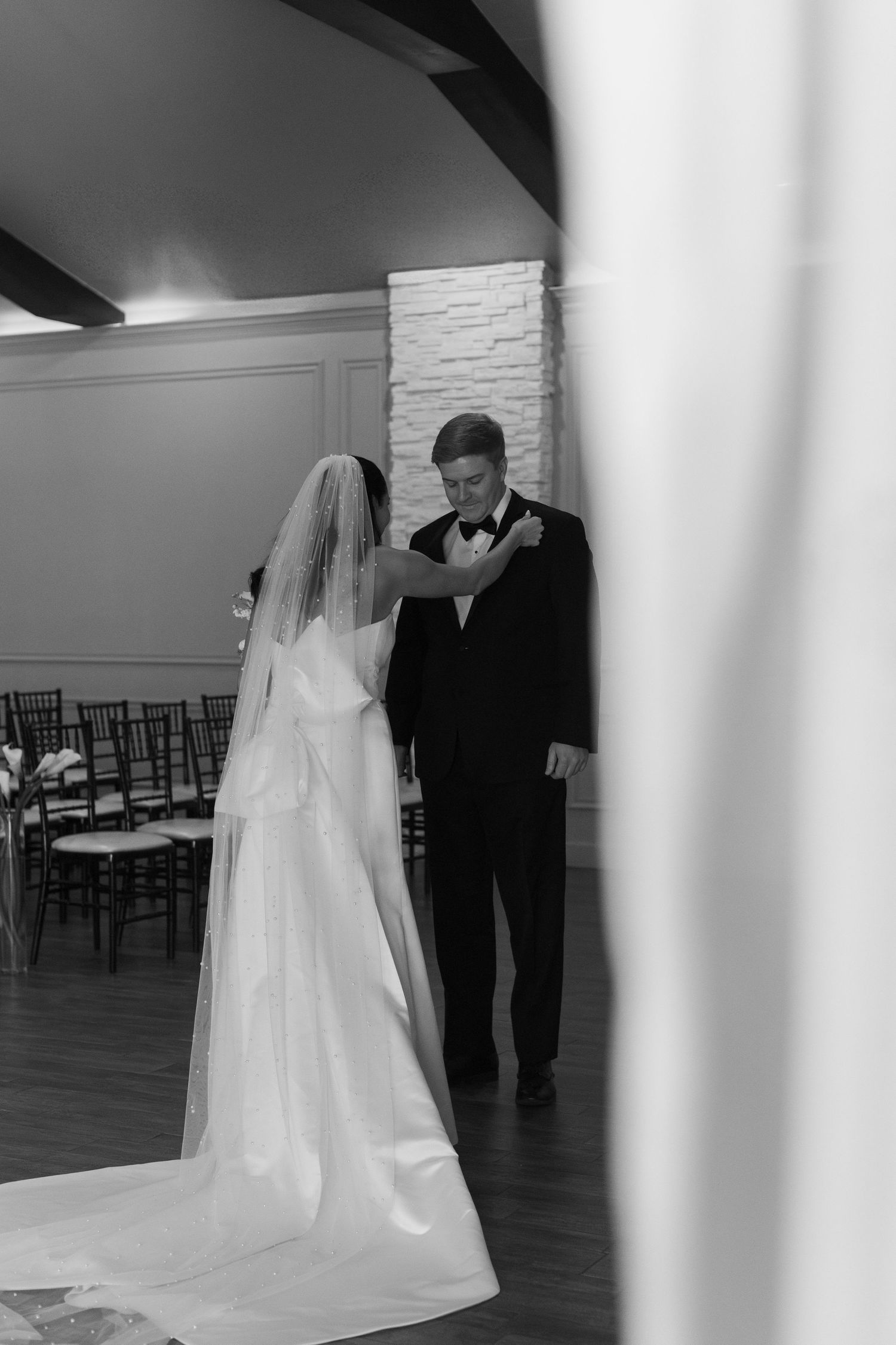 A wedding ceremony space with white draping and elegant details.