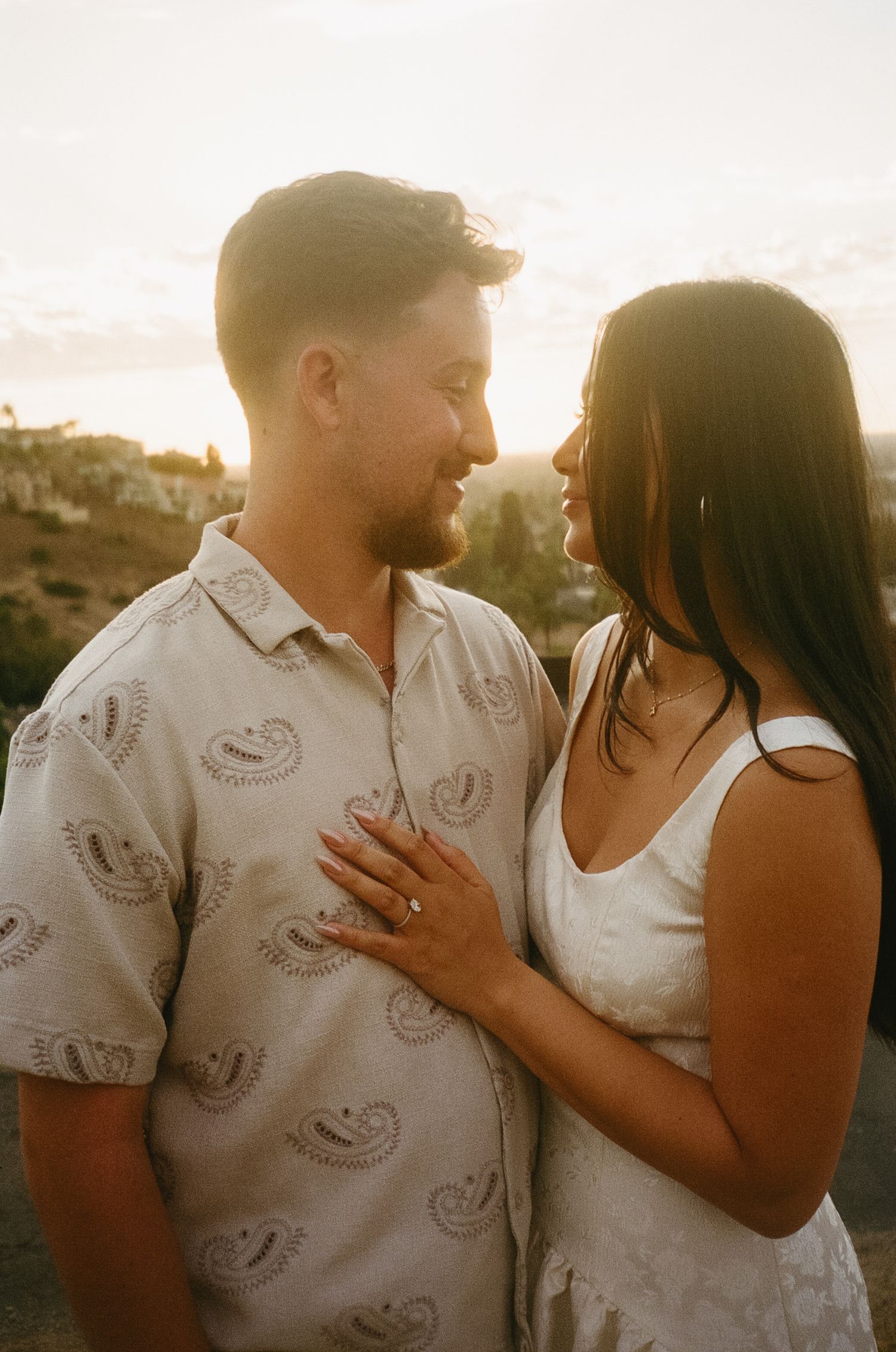 A romantic couple shares tender moments at sunset in a series of four connected photos.