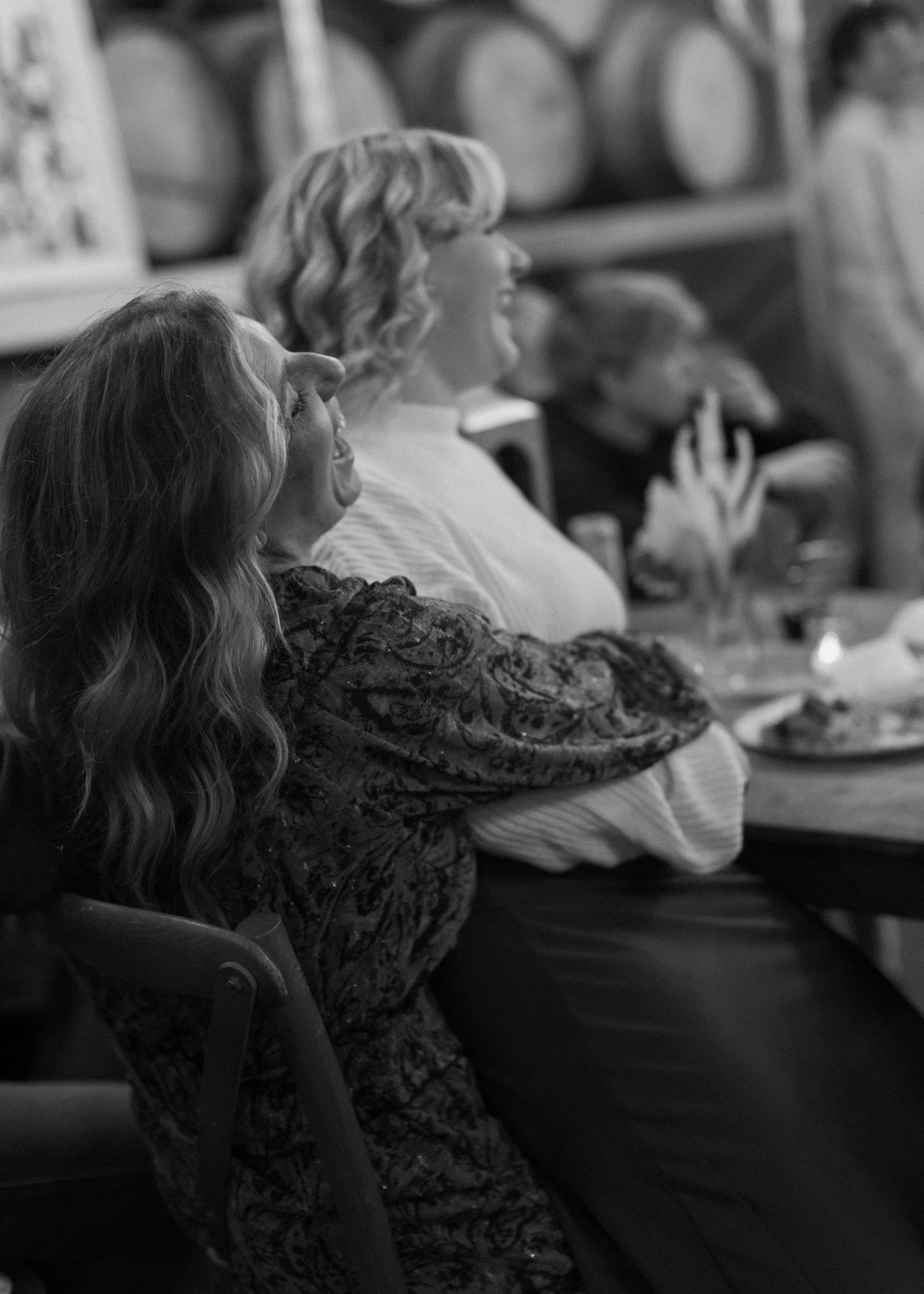Black and white image of guests dining at an elegant event.