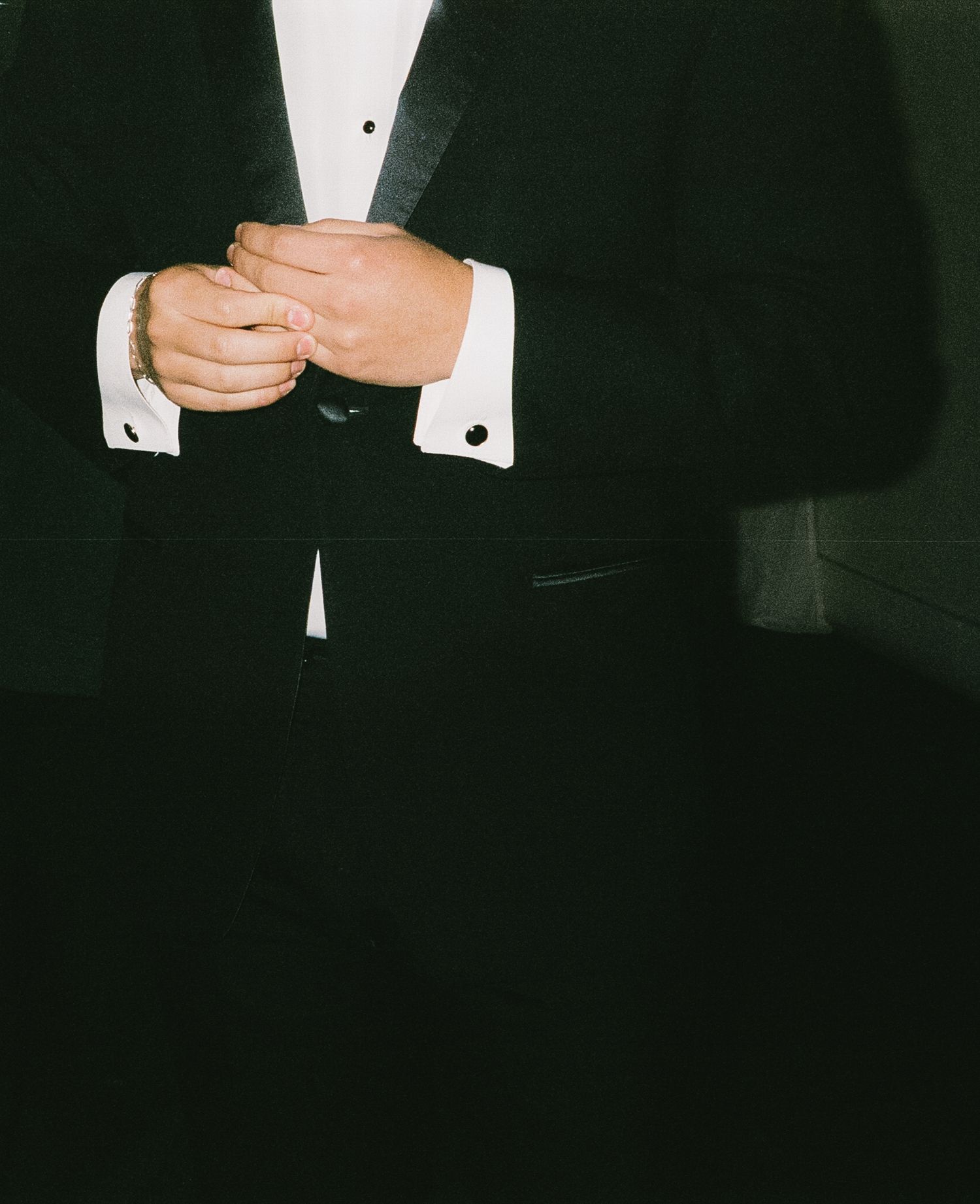 Close-up of formal tuxedo with white shirt and cufflinks.