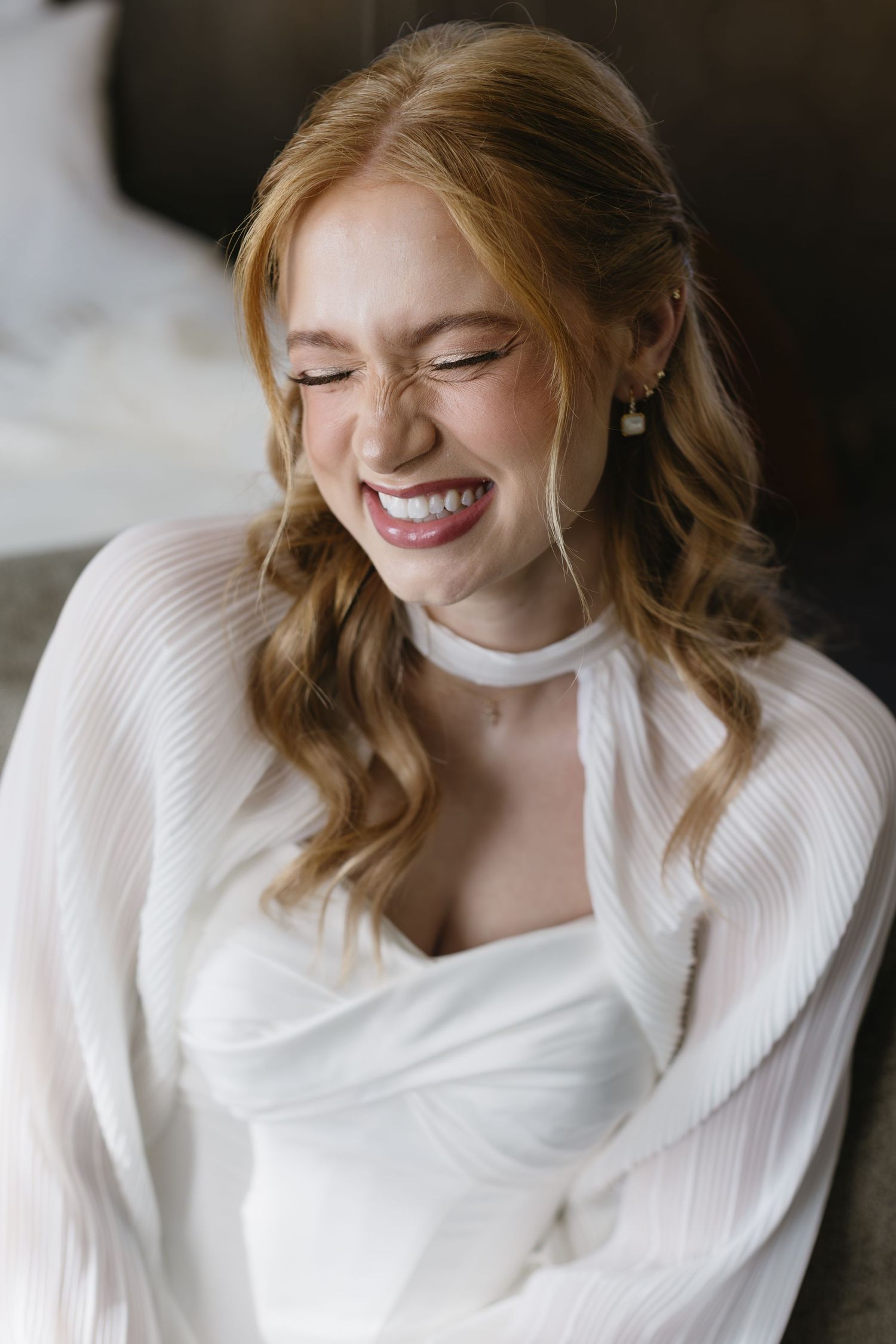 Candid moments of joy captured in bridal portraits showing genuine laughter and happiness.