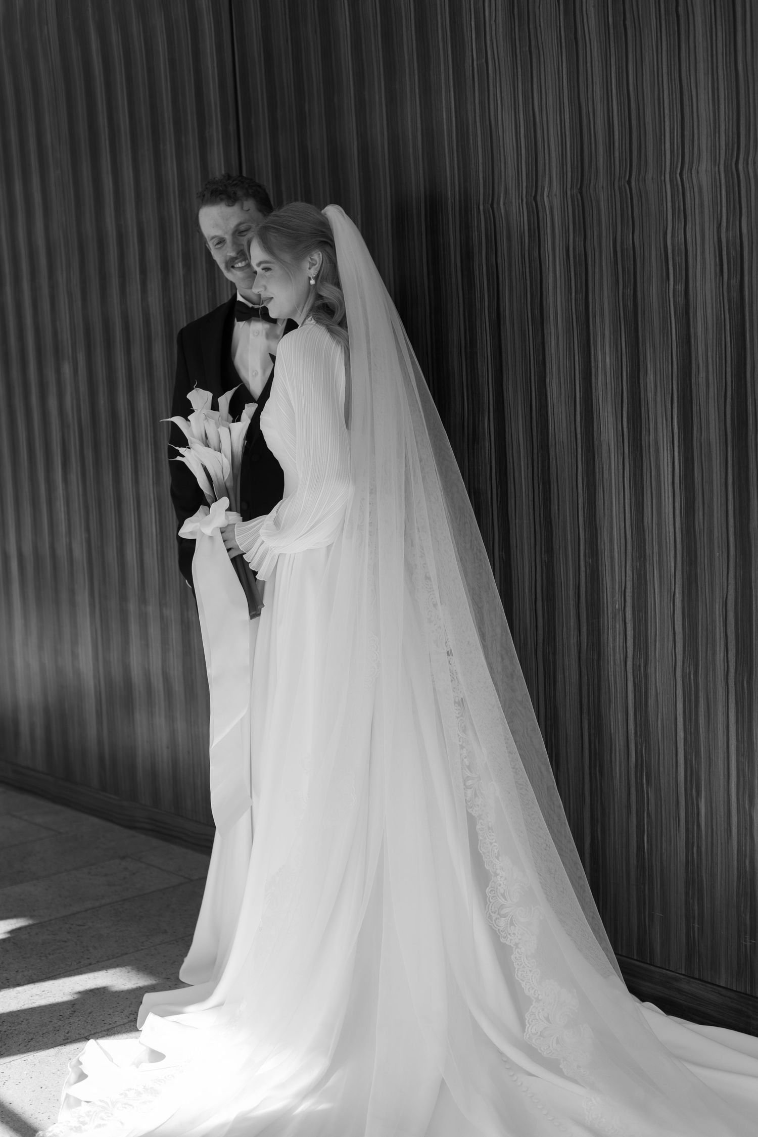 A sequence of elegant black and white wedding photos with flowing white dress and veil.