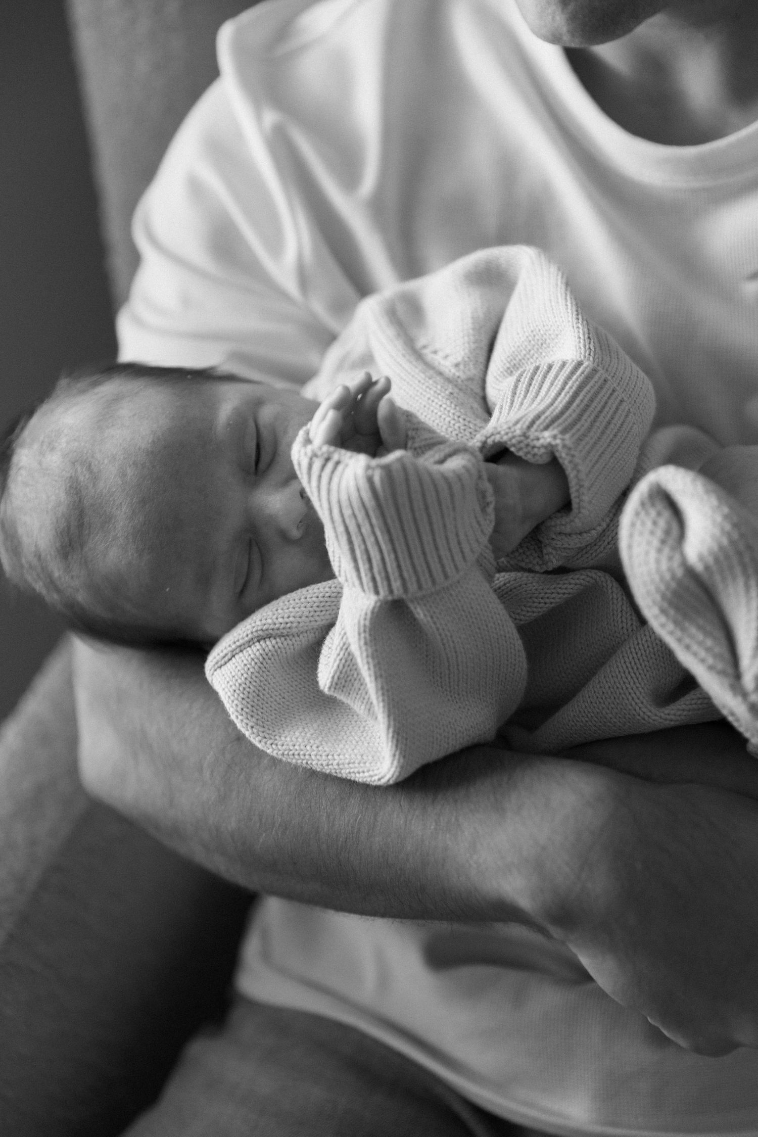 Close-up shots of tiny feet in white knit booties.