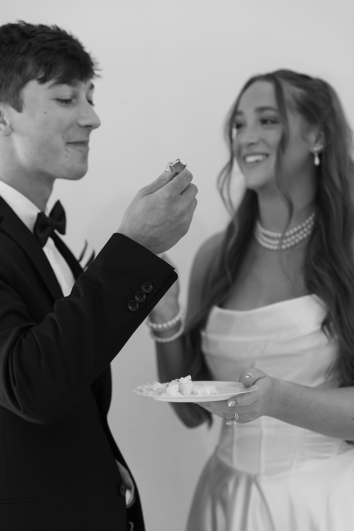 Black and white wedding portraits showing tender moments between newlyweds.