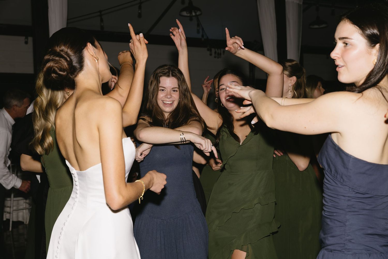 People dancing and having fun at a lively wedding reception party.
