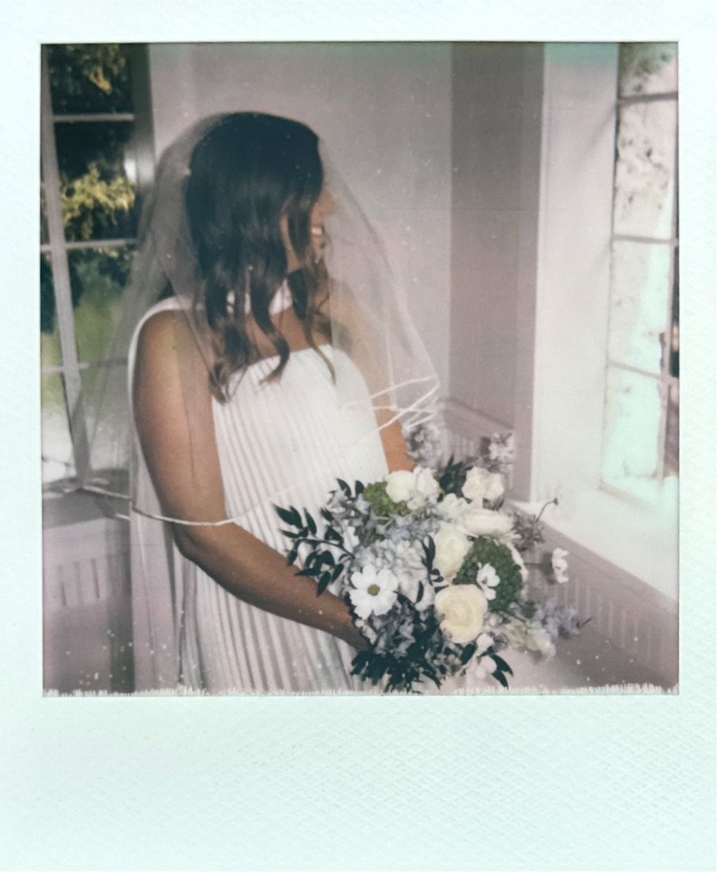 Soft focus polaroid-style wedding photos showing delicate bouquet details in vintage effect.