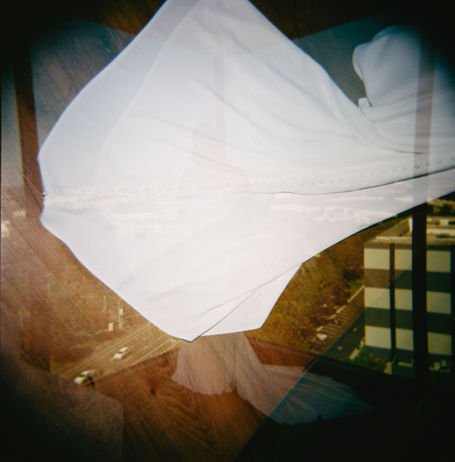 Abstract overlapping white shapes create an ethereal artistic composition with dark background.