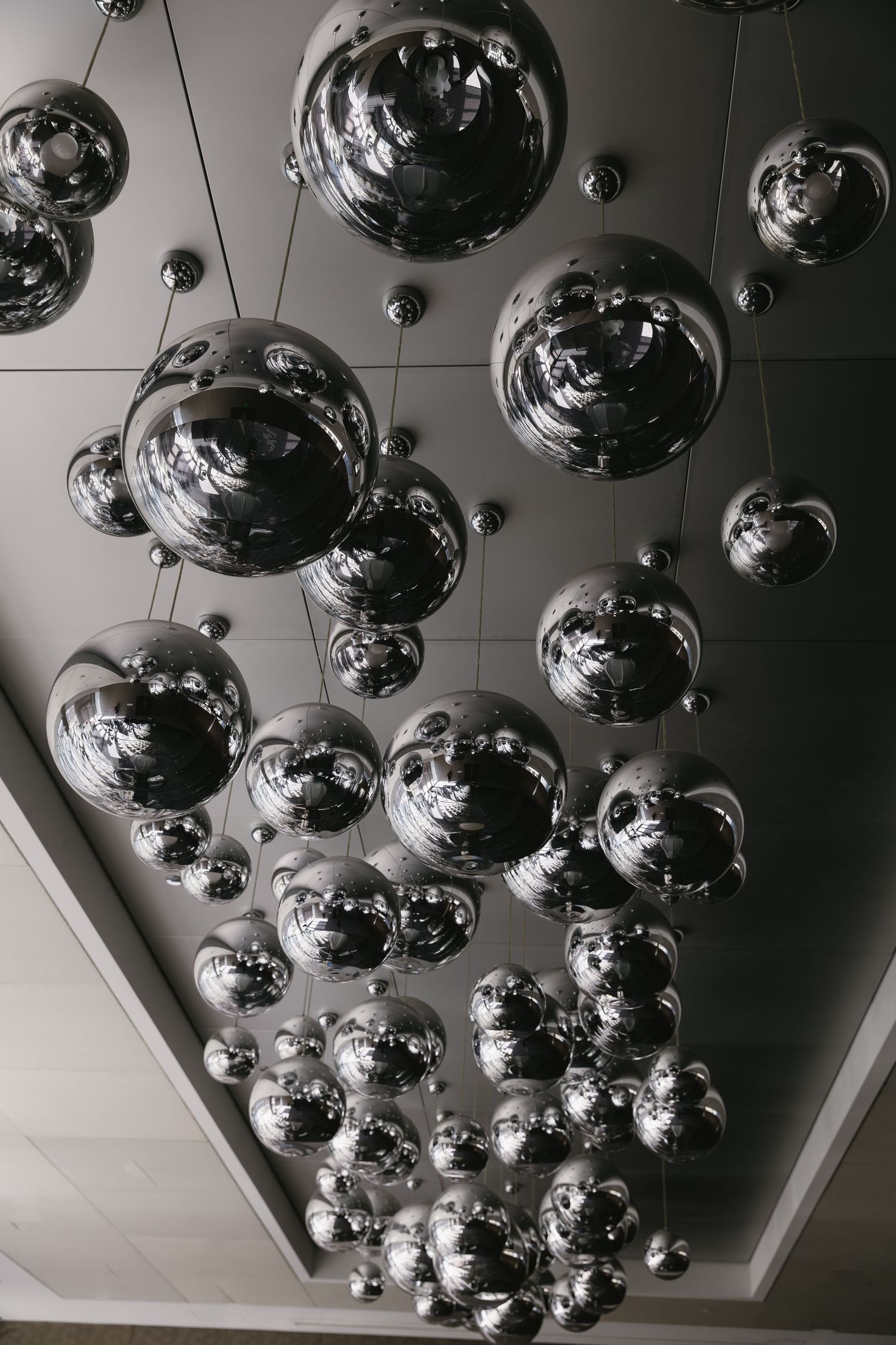 Modern ceiling installation featuring chrome sphere decorations.