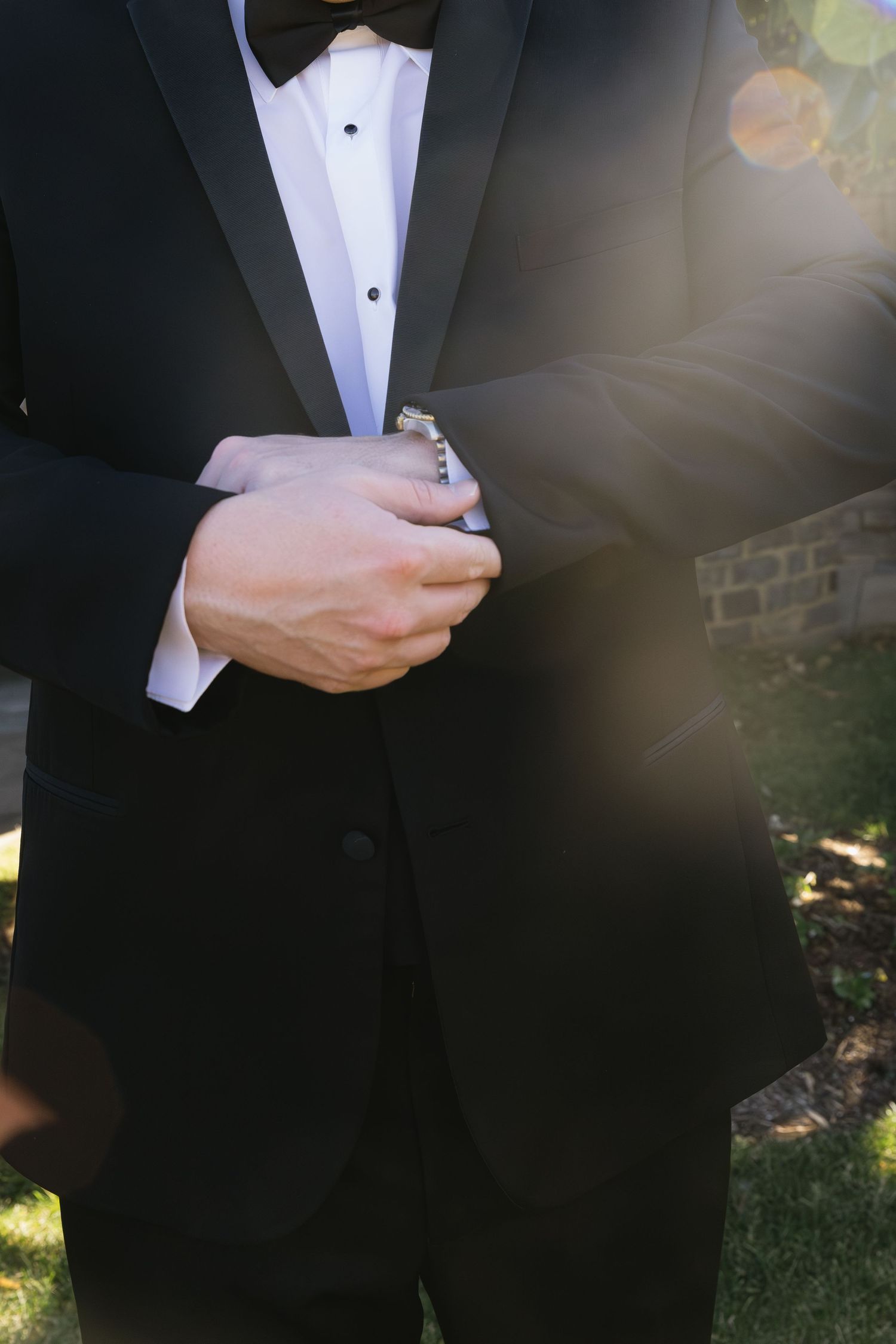 Close-up of a black tuxedo with white dress shirt and bow tie.