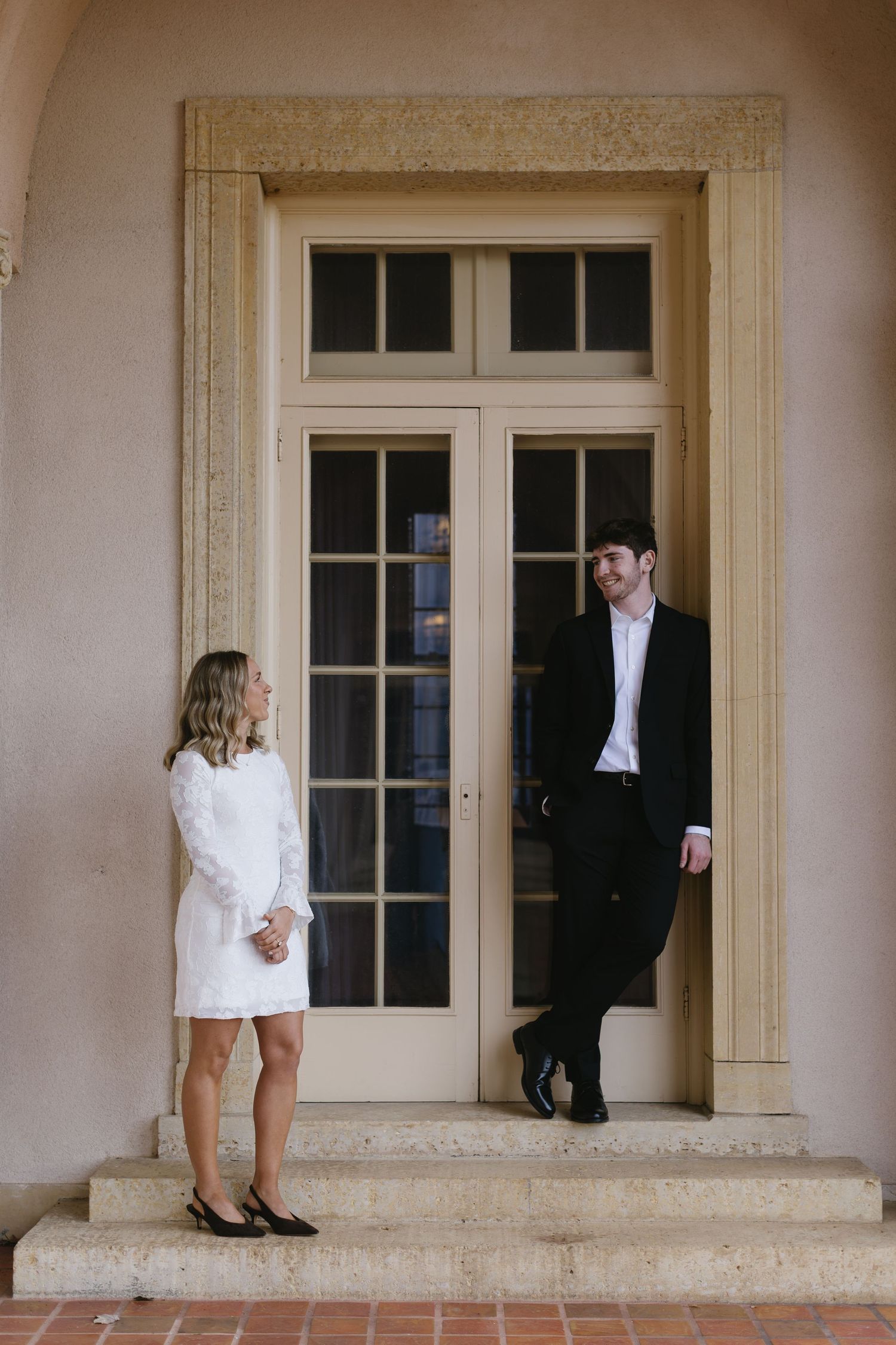 A series of romantic wedding photos showing a couple's feet and legs against an elegant doorway backdrop.