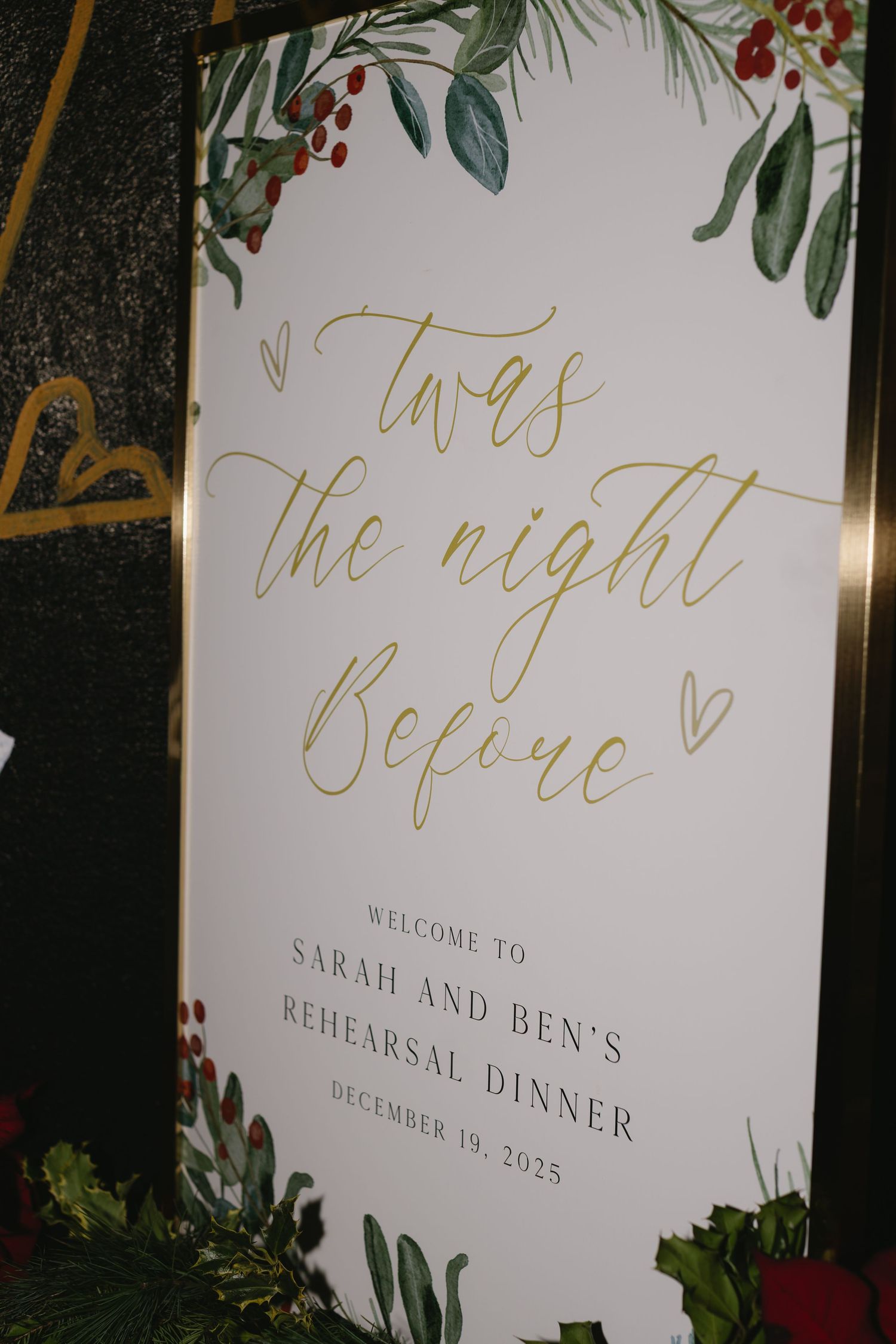 Elegant wedding rehearsal dinner welcome sign with floral design and gold calligraphy.