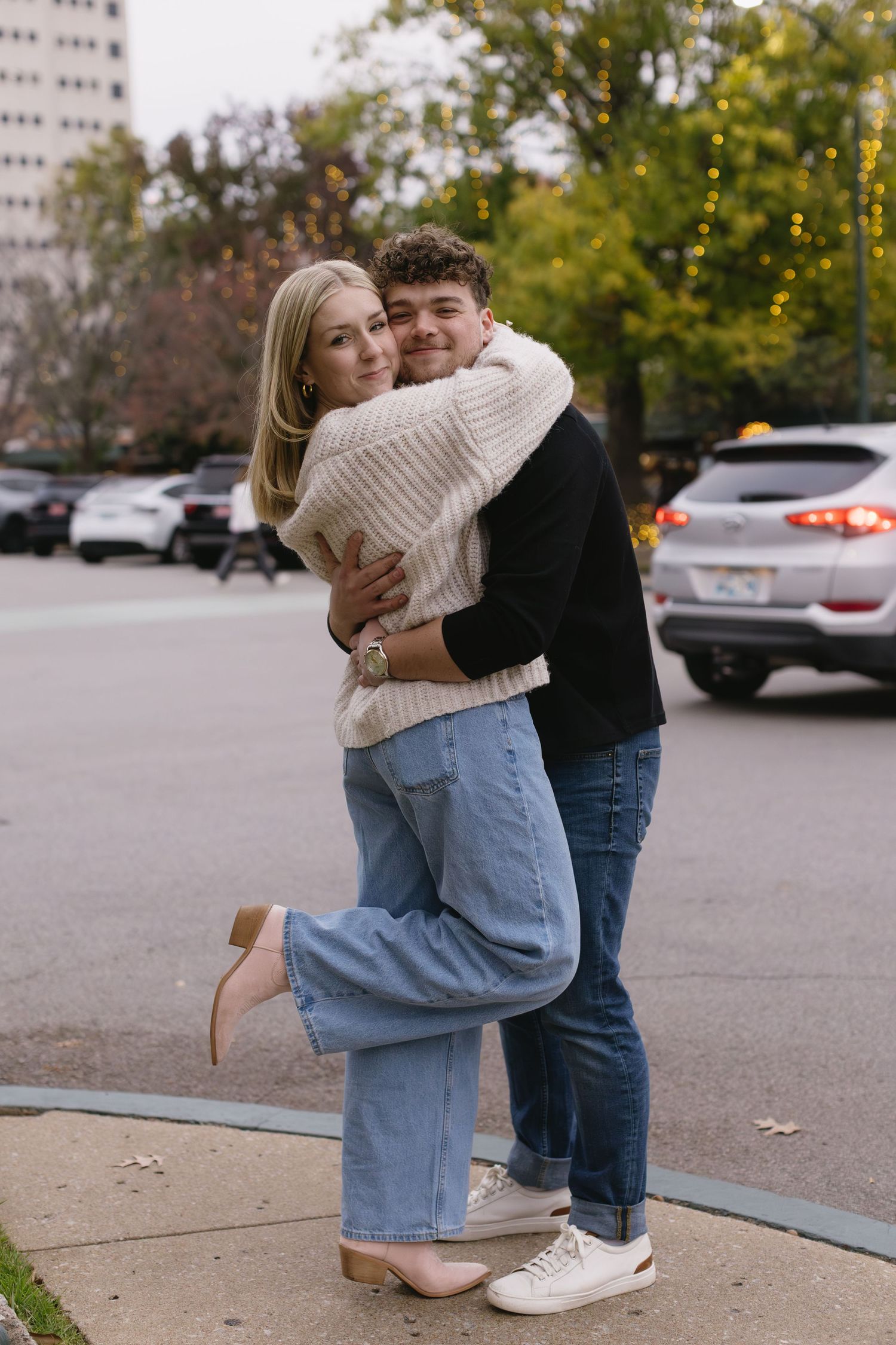 A sweet moment captured between a couple hugging on an autumn day in an urban setting.