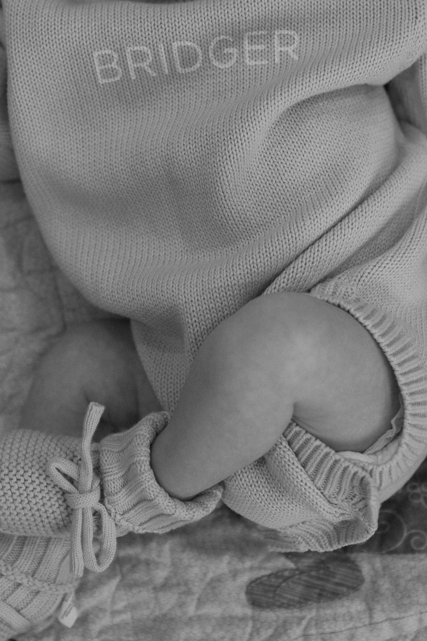 Close-up detail of soft knit baby clothing and fabric textures.