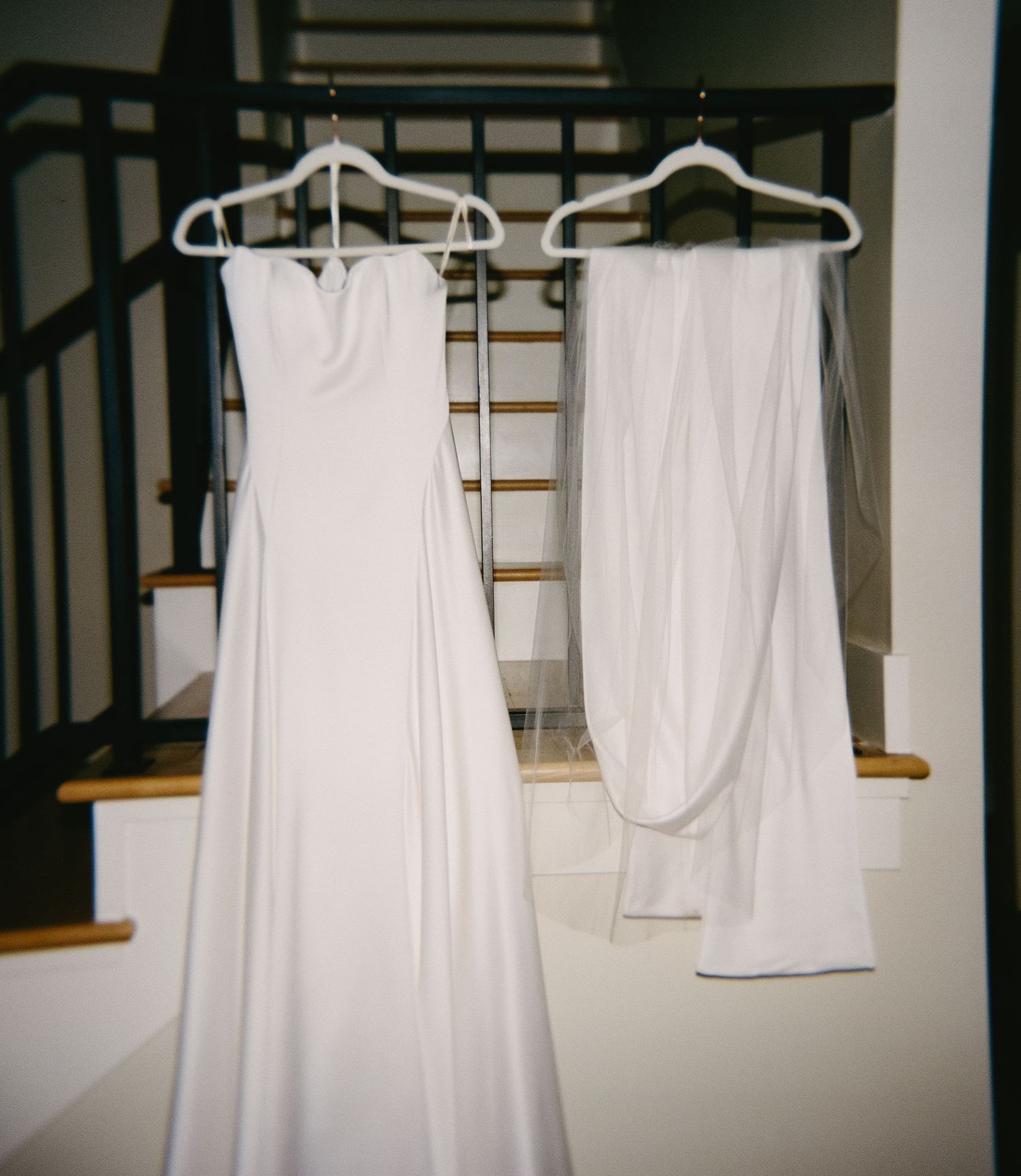 White wedding dresses hanging on display in a bridal preparation room.