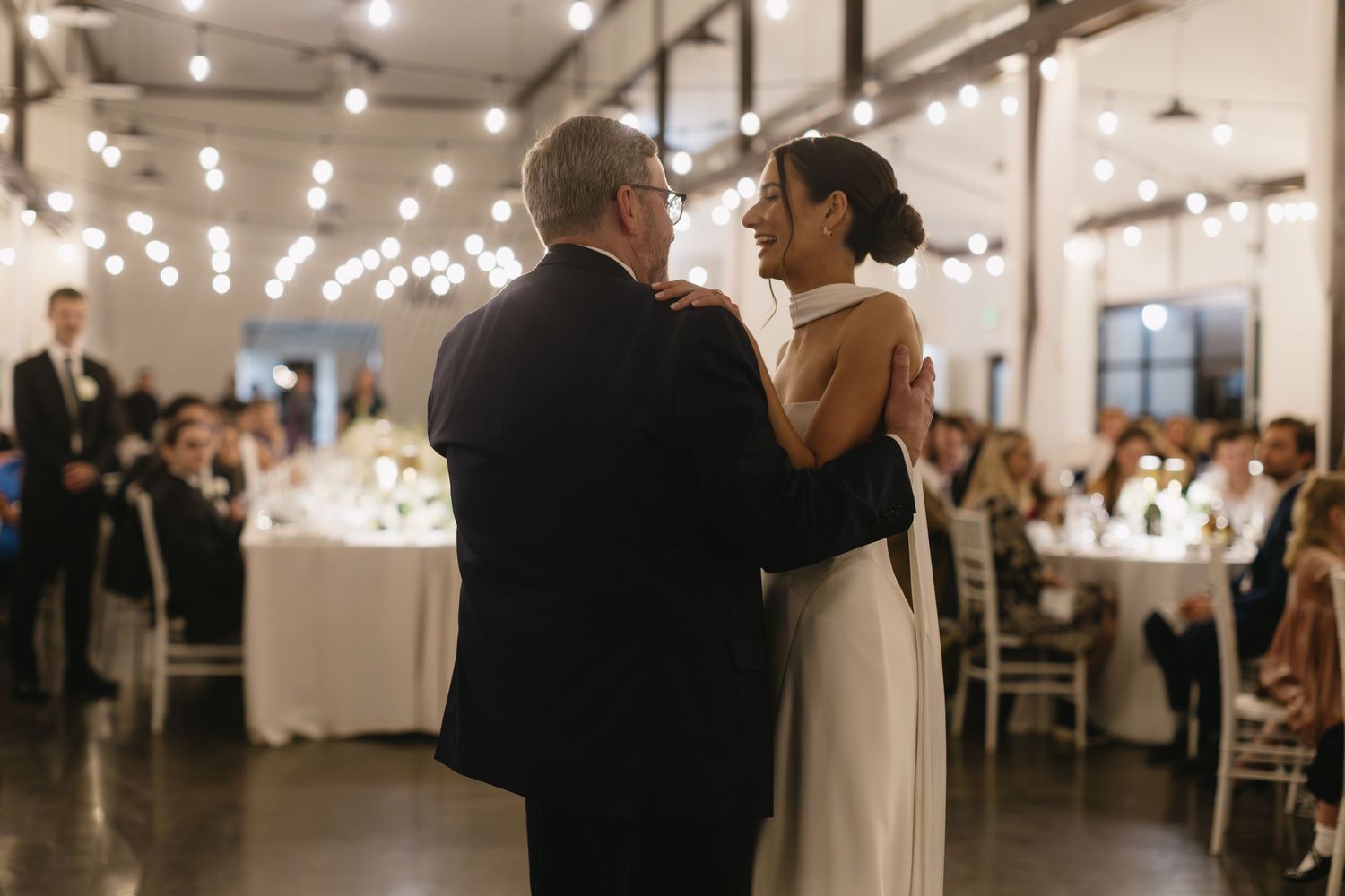 Modern indoor wedding reception venue with ambient lighting and elegant decor.
