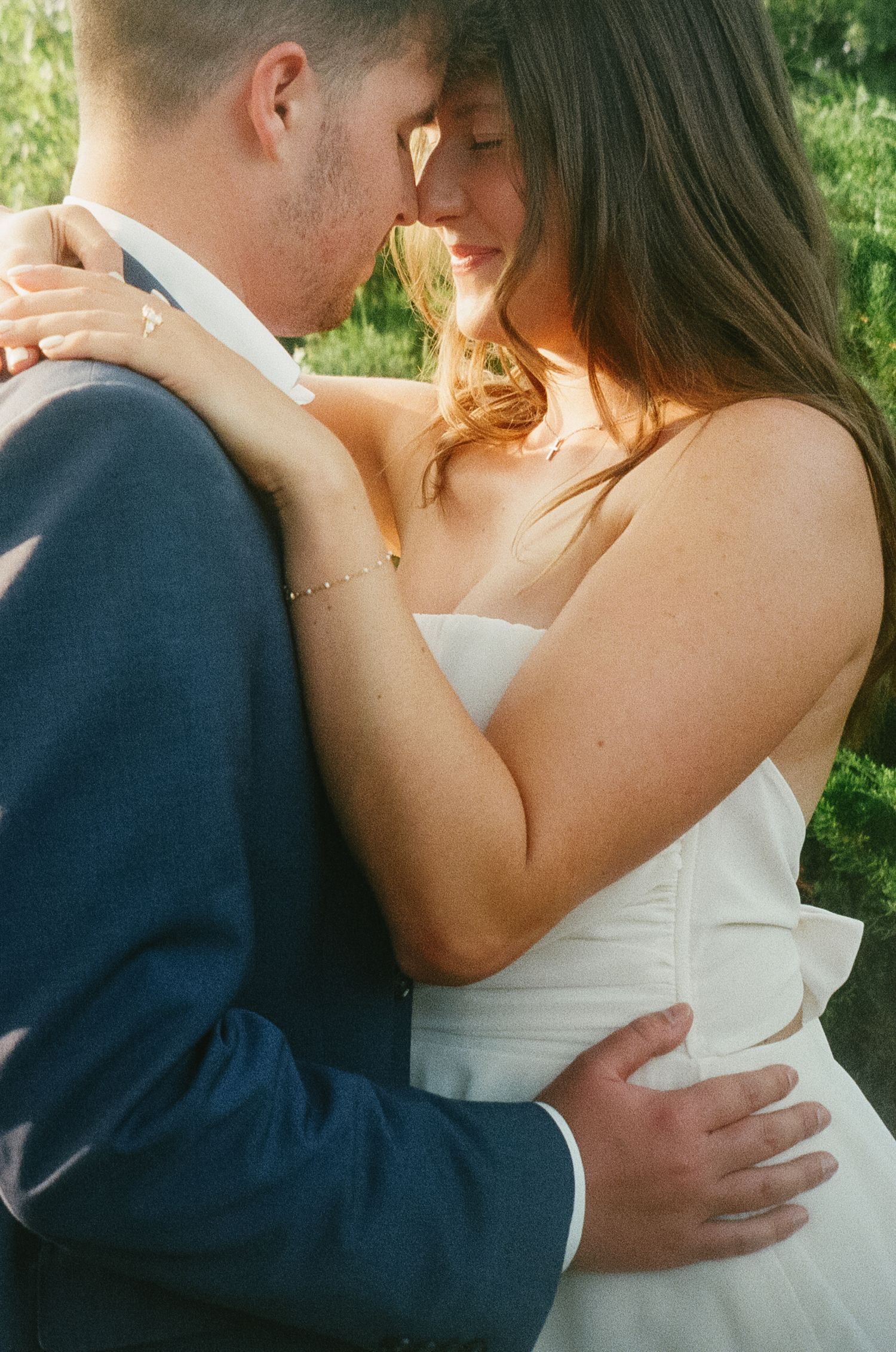 A series of romantic wedding photos showing a couple embracing in a garden setting.