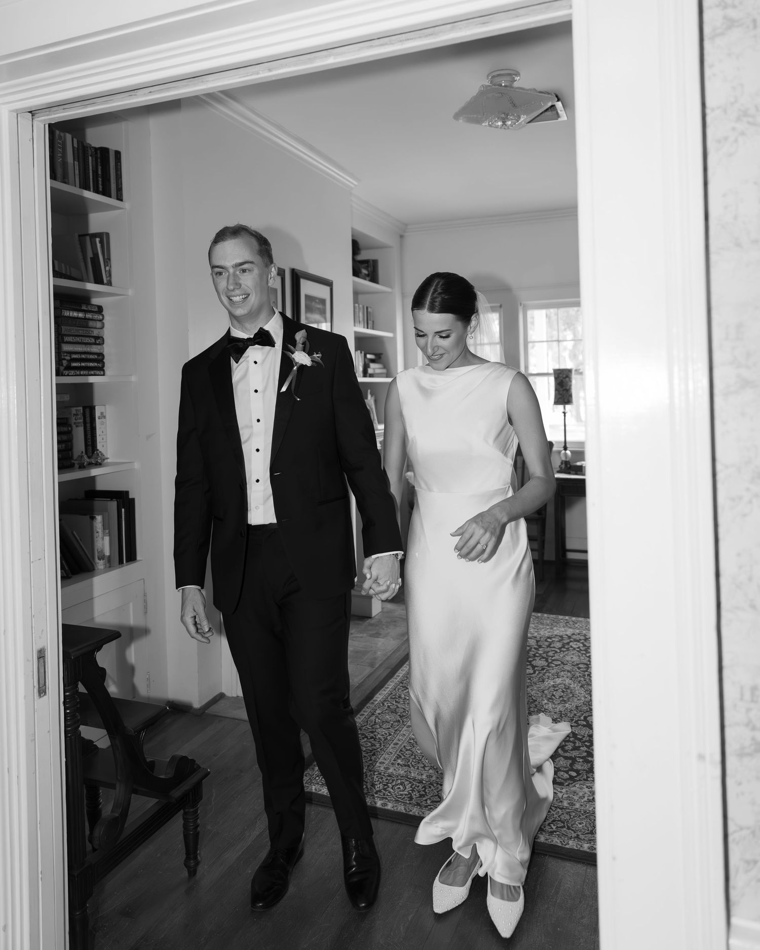 Black and white shots showing formal wedding attire and preparations in a sunlit room.