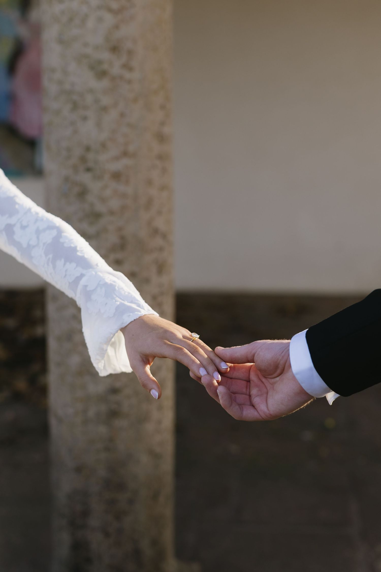 Close-up shots of hands exchanging rings during a wedding ceremony.