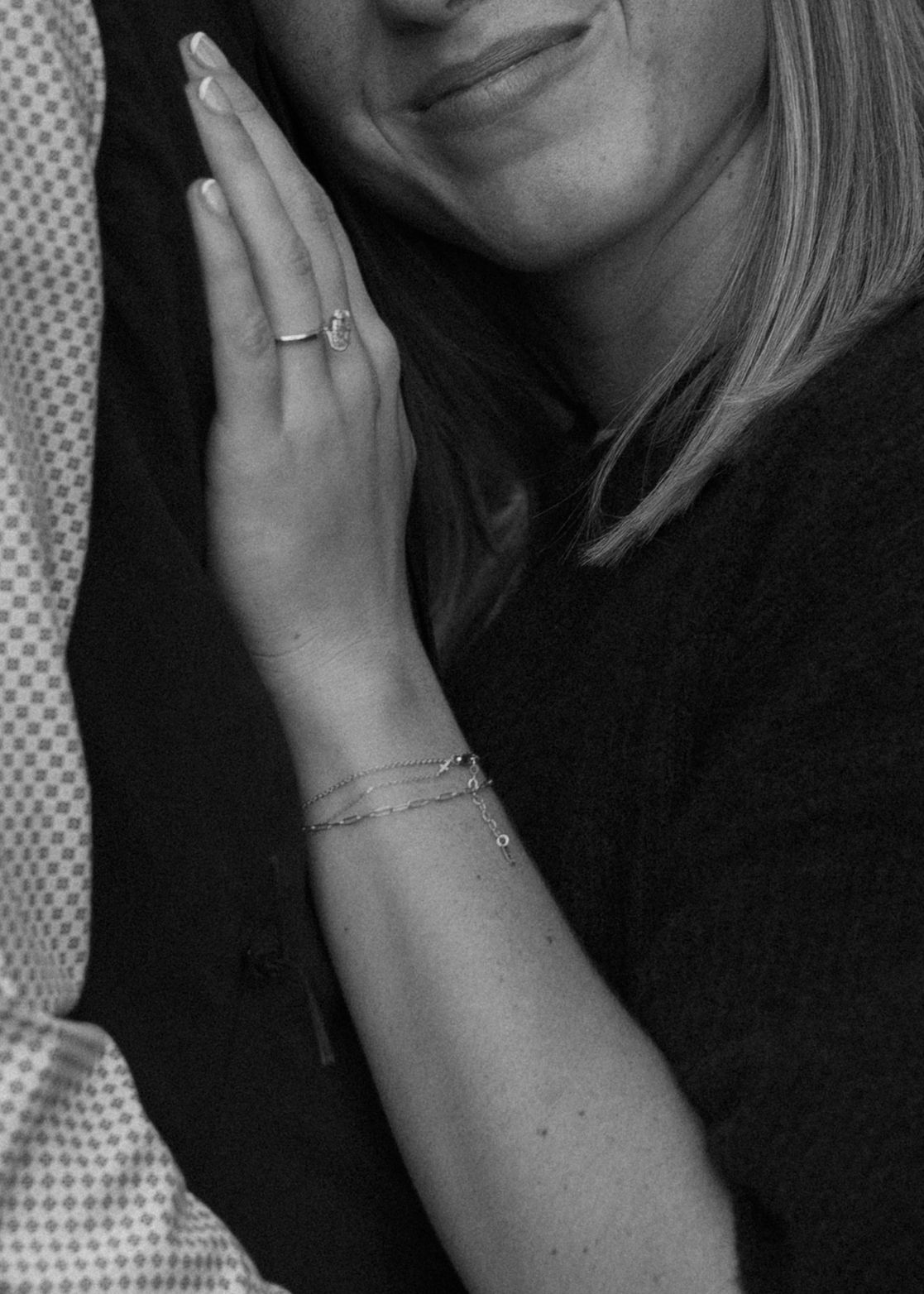 Close-up black and white portrait showing a gentle smile.