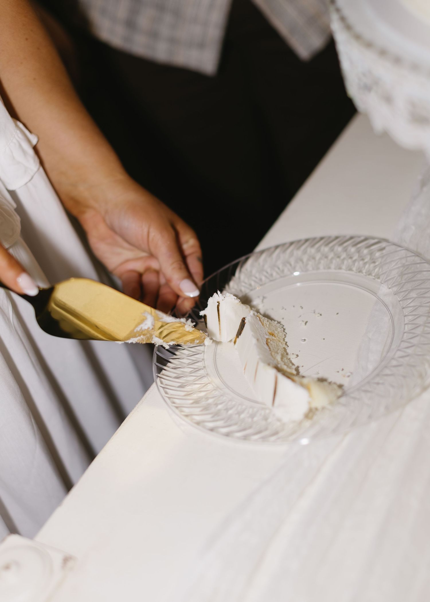White plates being served on an elegant tablecloth at a formal event.