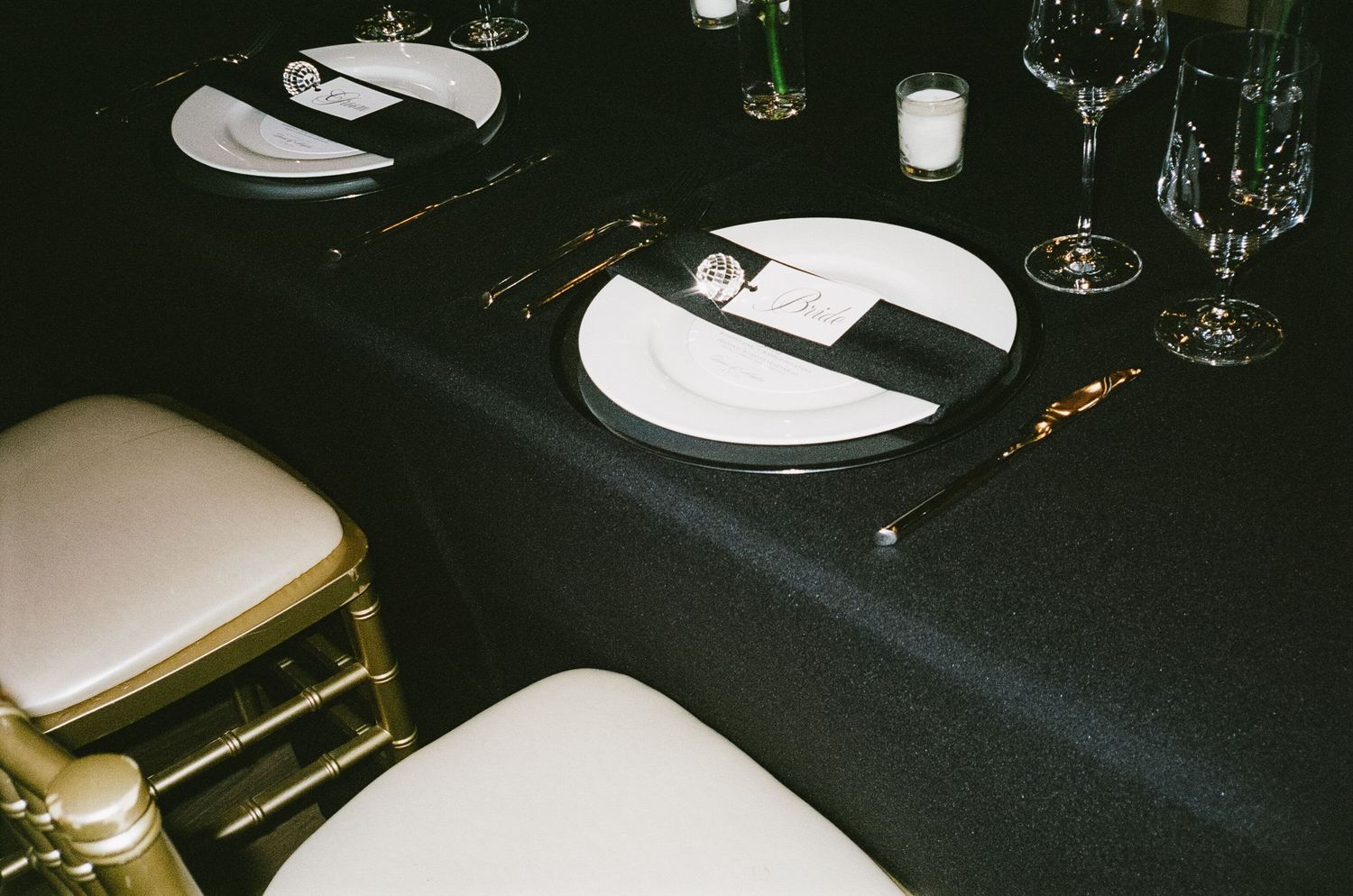 Elegant black and white table settings at a formal wedding reception.